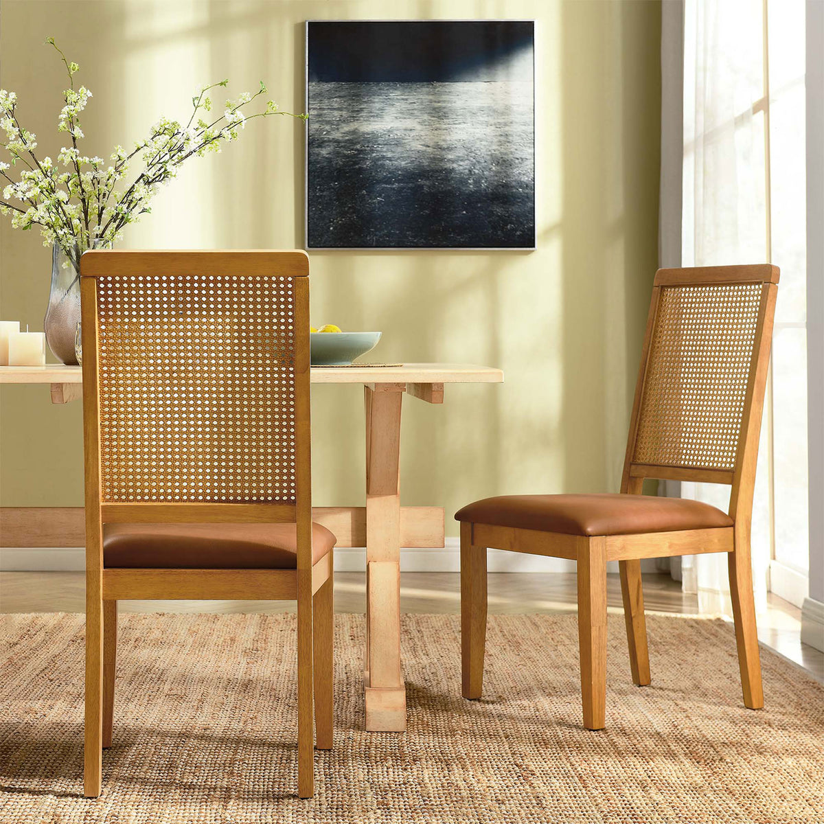 Dining room setting with two natural wood chairs around a light wood table on a woven rug || EEI-6802-NAT-NAT-TAN || back_angle_multi_room