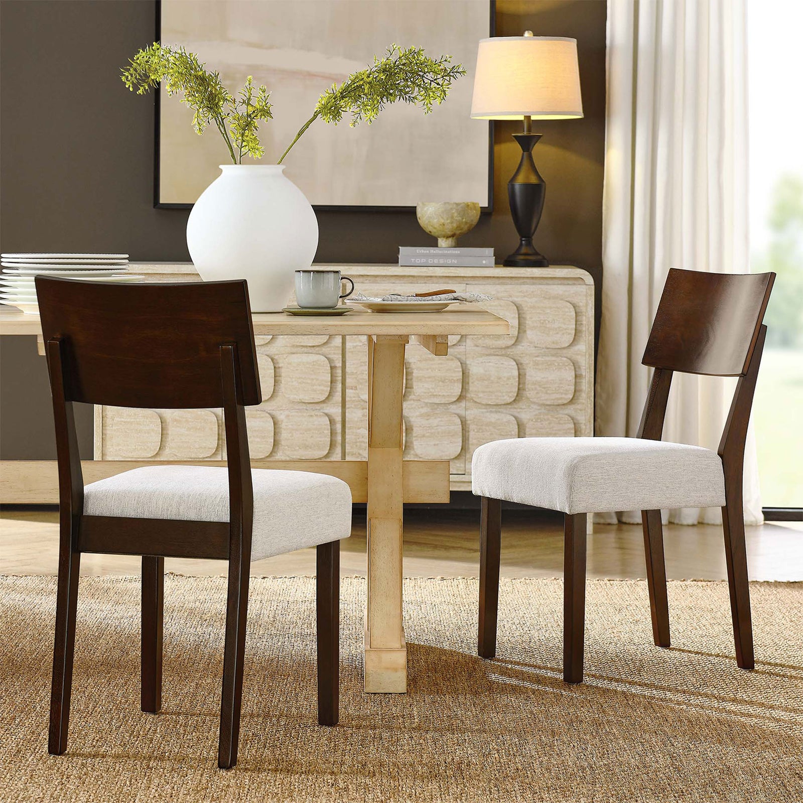 Pair of Pax dining chairs around a light wood table in a bright, contemporary dining room. || EEI-6804-WAL-HEI || front_angle_multi_room