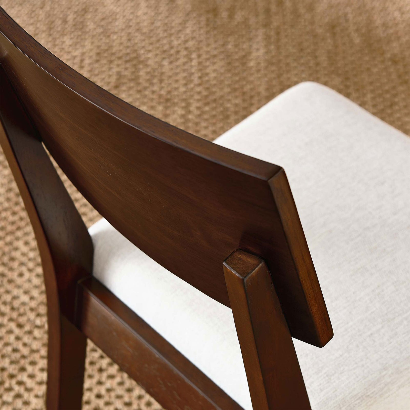Walnut dining chair with ivory seat styled on a textured rug for a warm, inviting look. || EEI-6804-WAL-HEI || detail_room