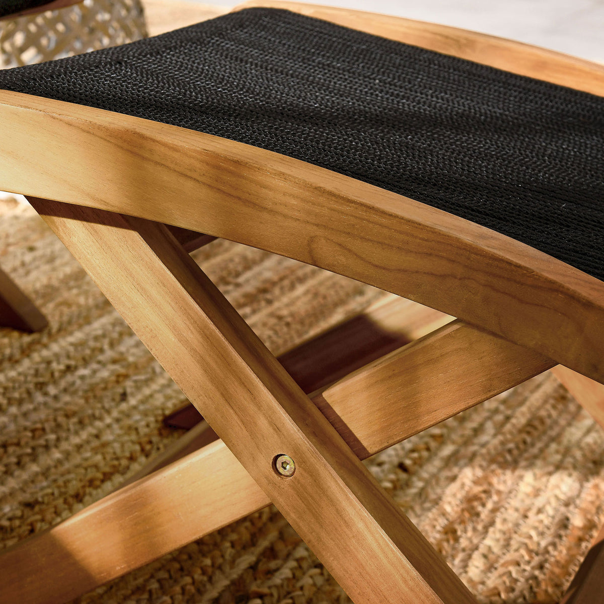 Curved teak frame and black rope weave bring refined texture to this outdoor folding ottoman || EEI-6809-NAT-BLK || swatch_room