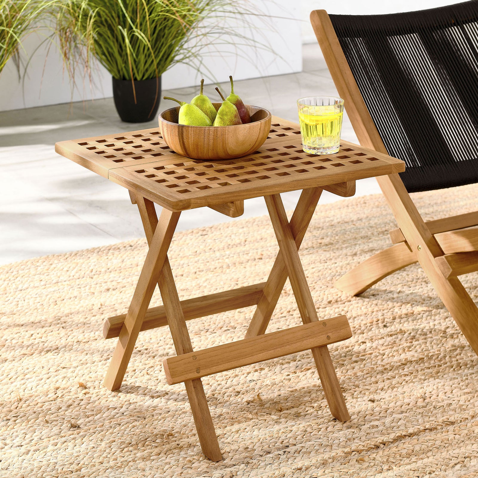 Vienna teak folding side table beside lounge chair for drinks and decor outdoors || EEI-6810-NAT || front_angle_room