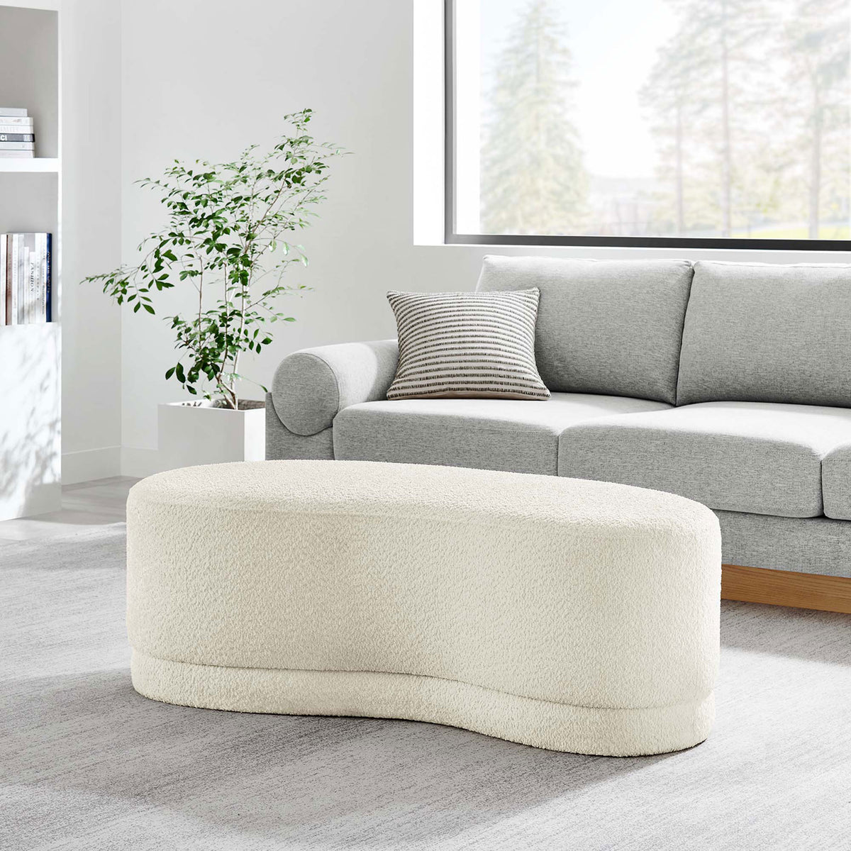 Nimbus cream ottoman bench anchors a modern living room, pairing effortlessly with a gray sofa. || EEI-6816-CRE || front_angle_room