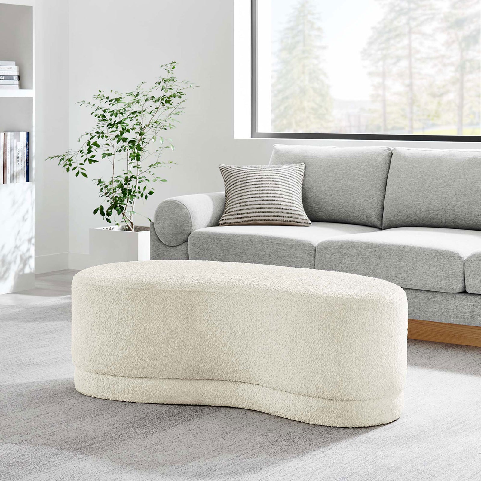 Nimbus cream ottoman bench anchors a modern living room, pairing effortlessly with a gray sofa. || EEI-6816-CRE || front_angle_room