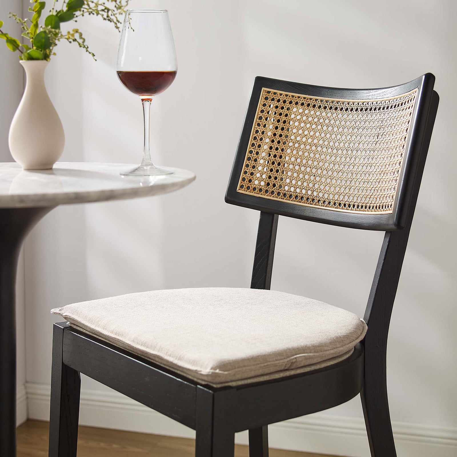 Soft beige upholstery pairs with open cane for an inviting bar-side seat || EEI-6820-BLK-BEI || detail_room