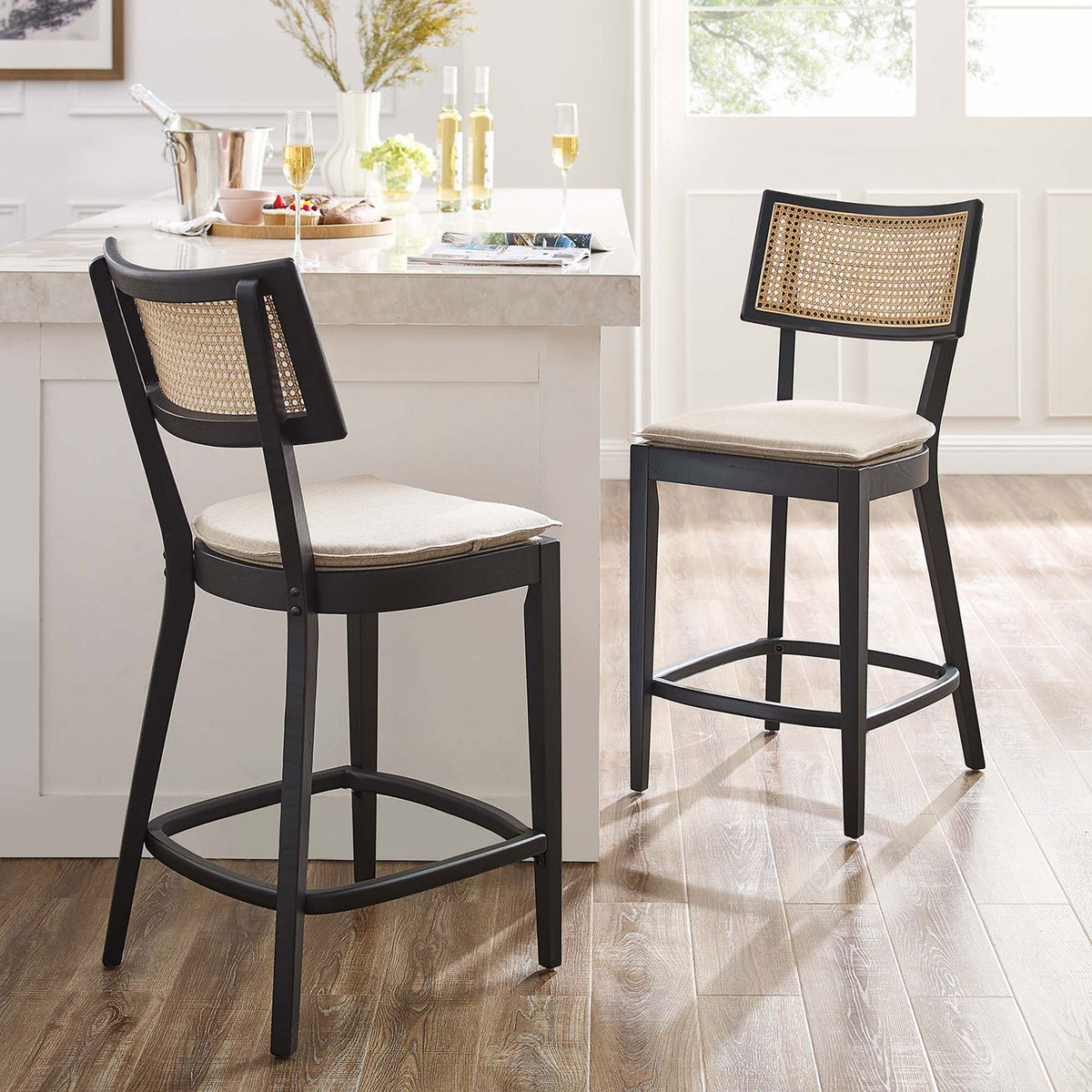 Pair of counter stools elevates a bright kitchen with warm cane and soft neutrals || EEI-6821-BLK-BEI || front_angle_multi_room