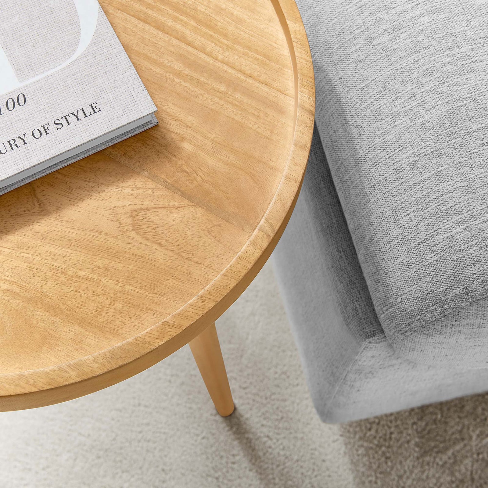 Lifestyle closeup of the natural wood tray table beside a light gray sofa with a book on top || EEI-6830-NAT || detail_room