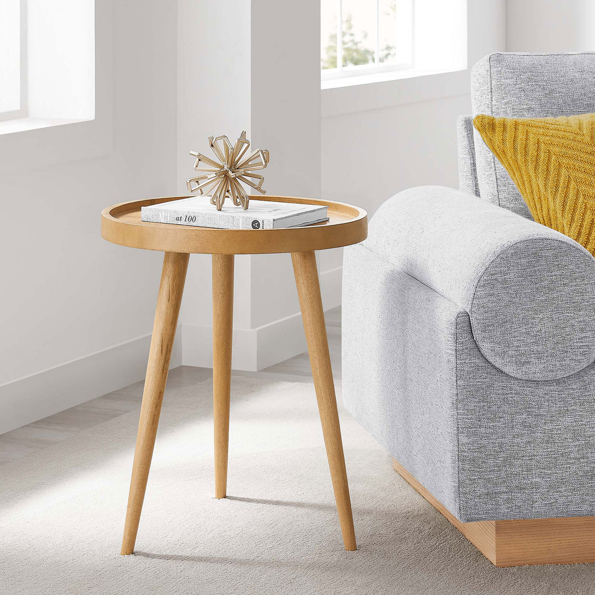 Natural mango wood side table styled in a sunlit living room next to a light gray sofa || EEI-6830-NAT || front_angle_room