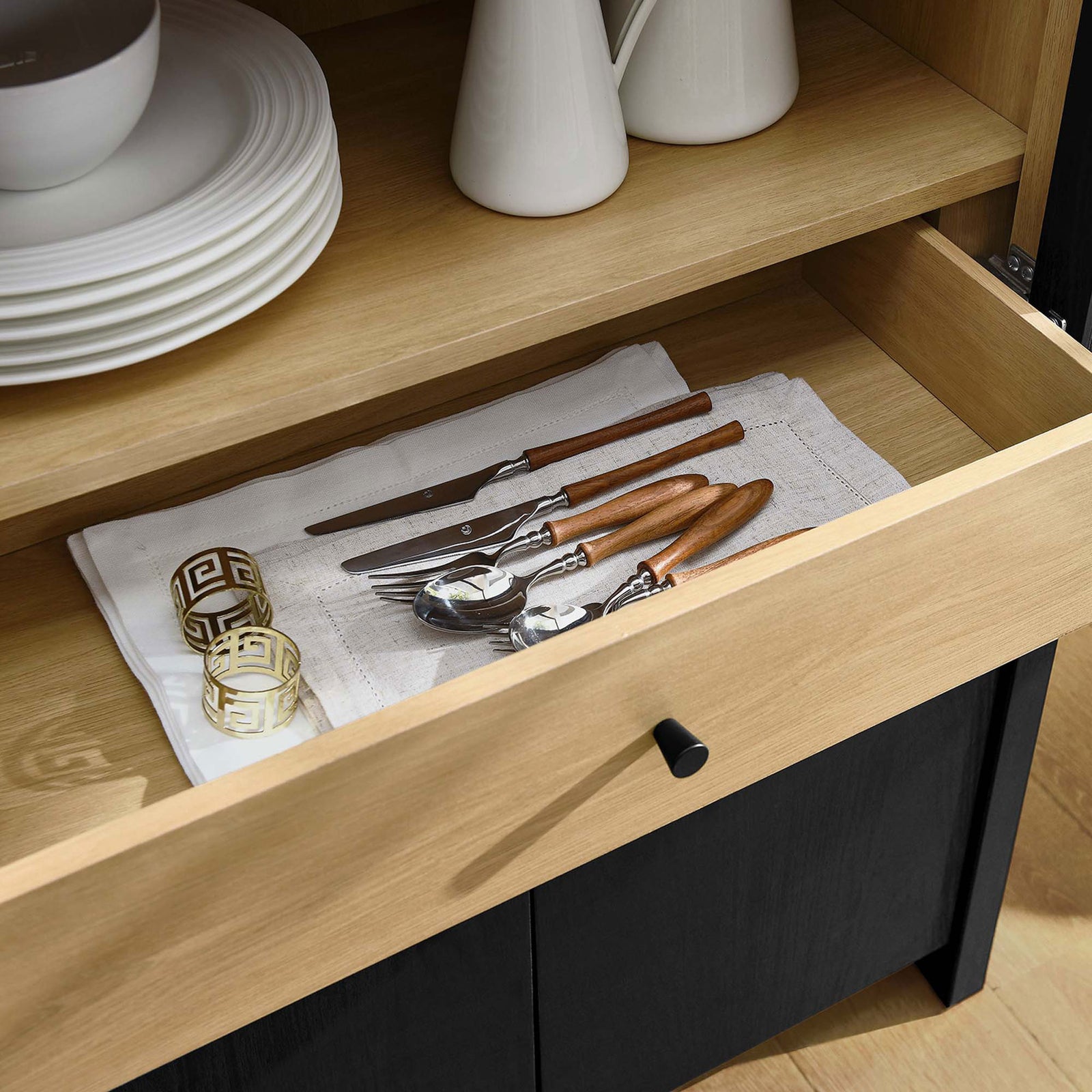 Evie cabinet drawer in a dining space organizing flatware and serveware within easy reach || EEI-6834-BLK-OAK || storage_open_room