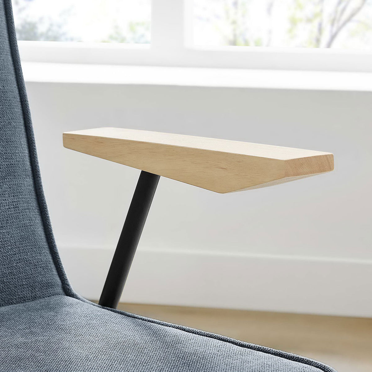 Detail of light wood armrest and blue fabric seat of Vista Laguna dining chair in a sunlit room || EEI-6835-LAG || detail_room