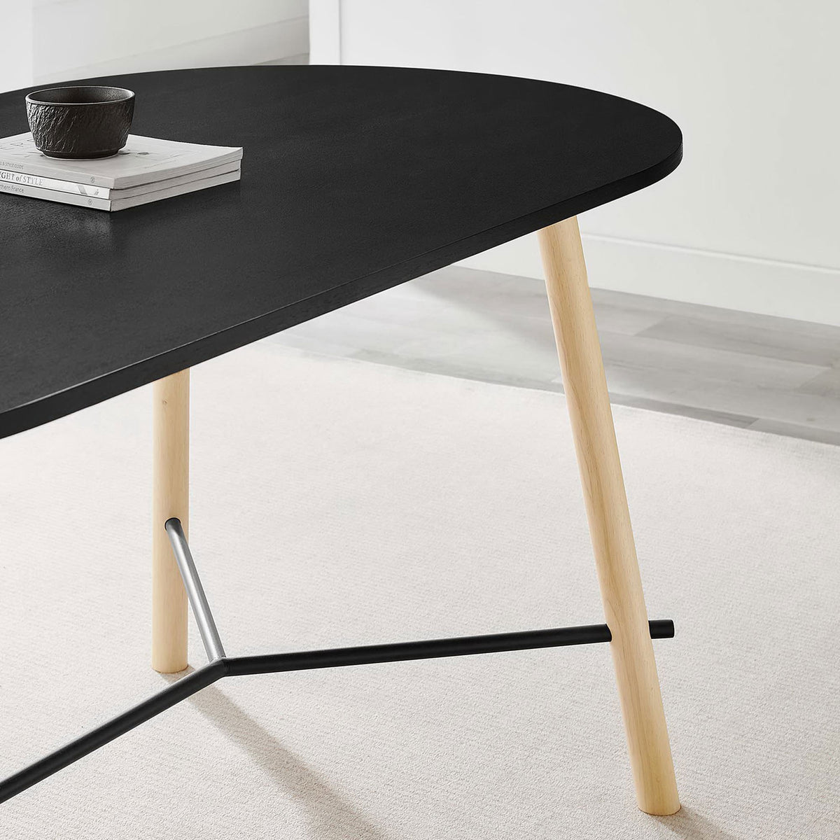 Styled dining tabletop vignette with black finish, light wood leg, and minimalist decor in a bright room || EEI-6836-BLK-OAK || detail_room