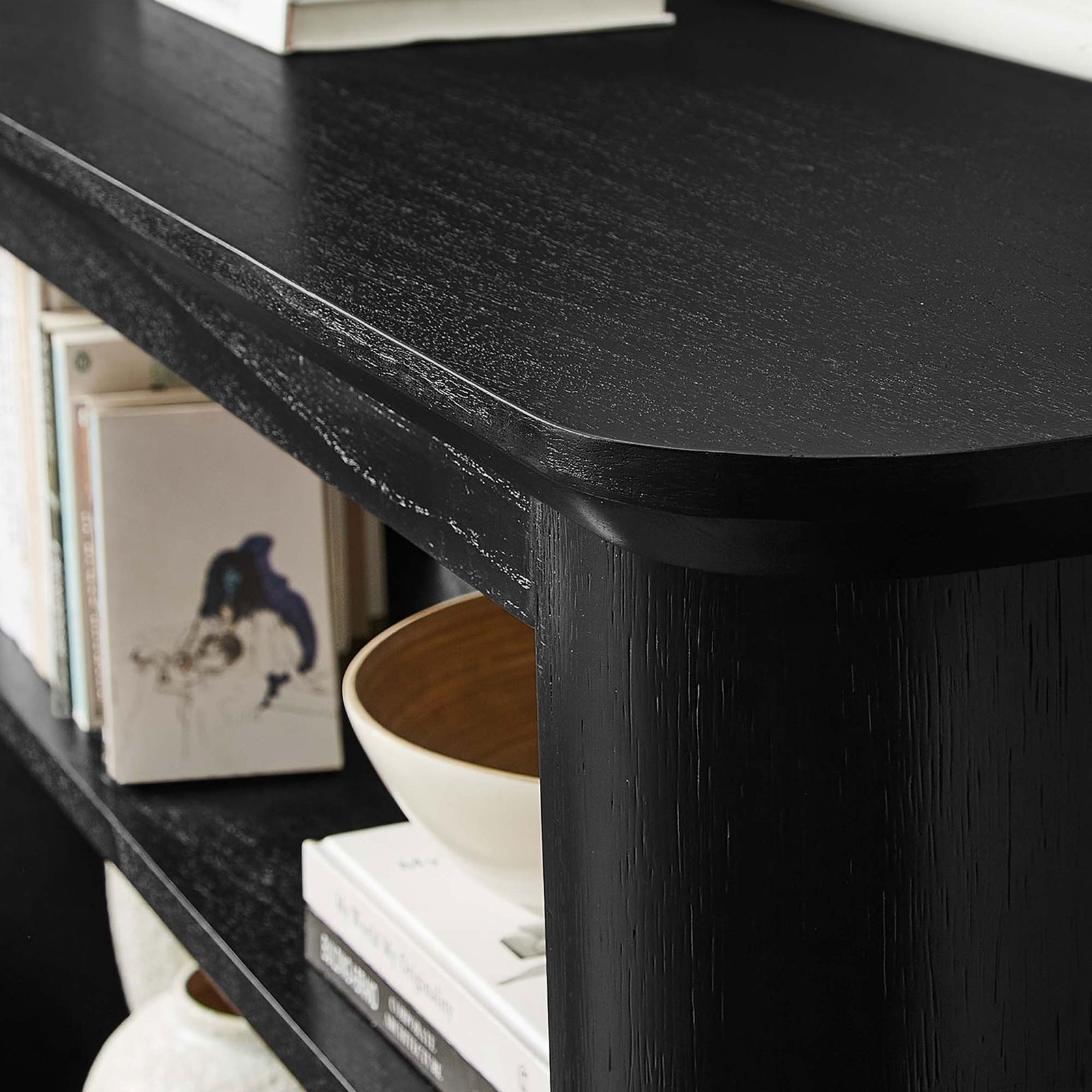 Rich black wood grain and rounded edges complement books and decor on the open shelves || EEI-6849-BLK || detail_room