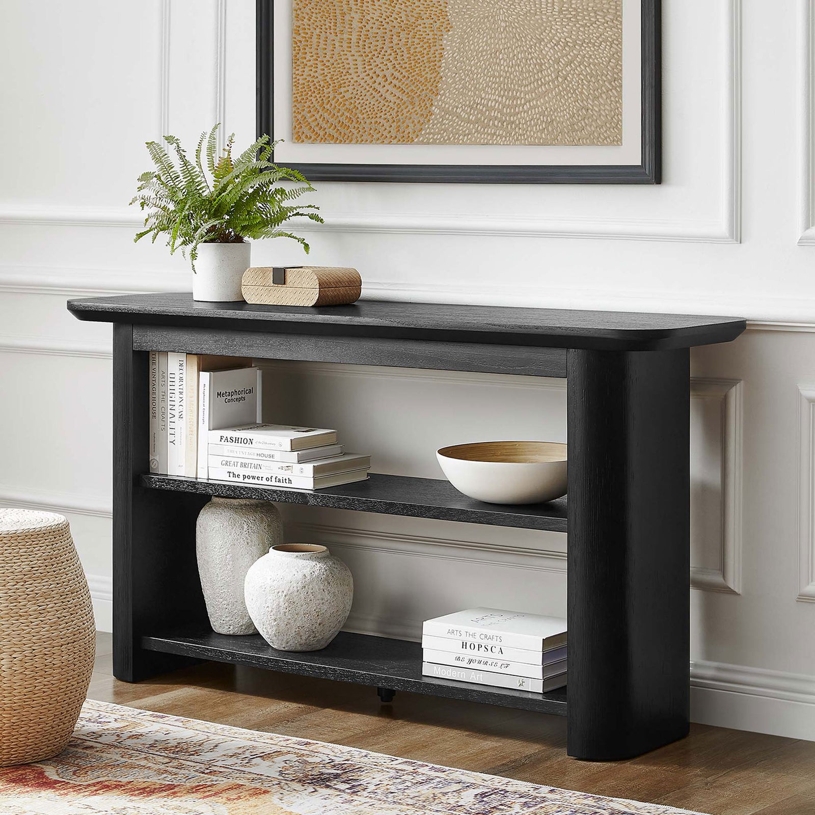 Modern black console table styled in a living room, featuring two open shelves for display and storage || EEI-6849-BLK || front_room