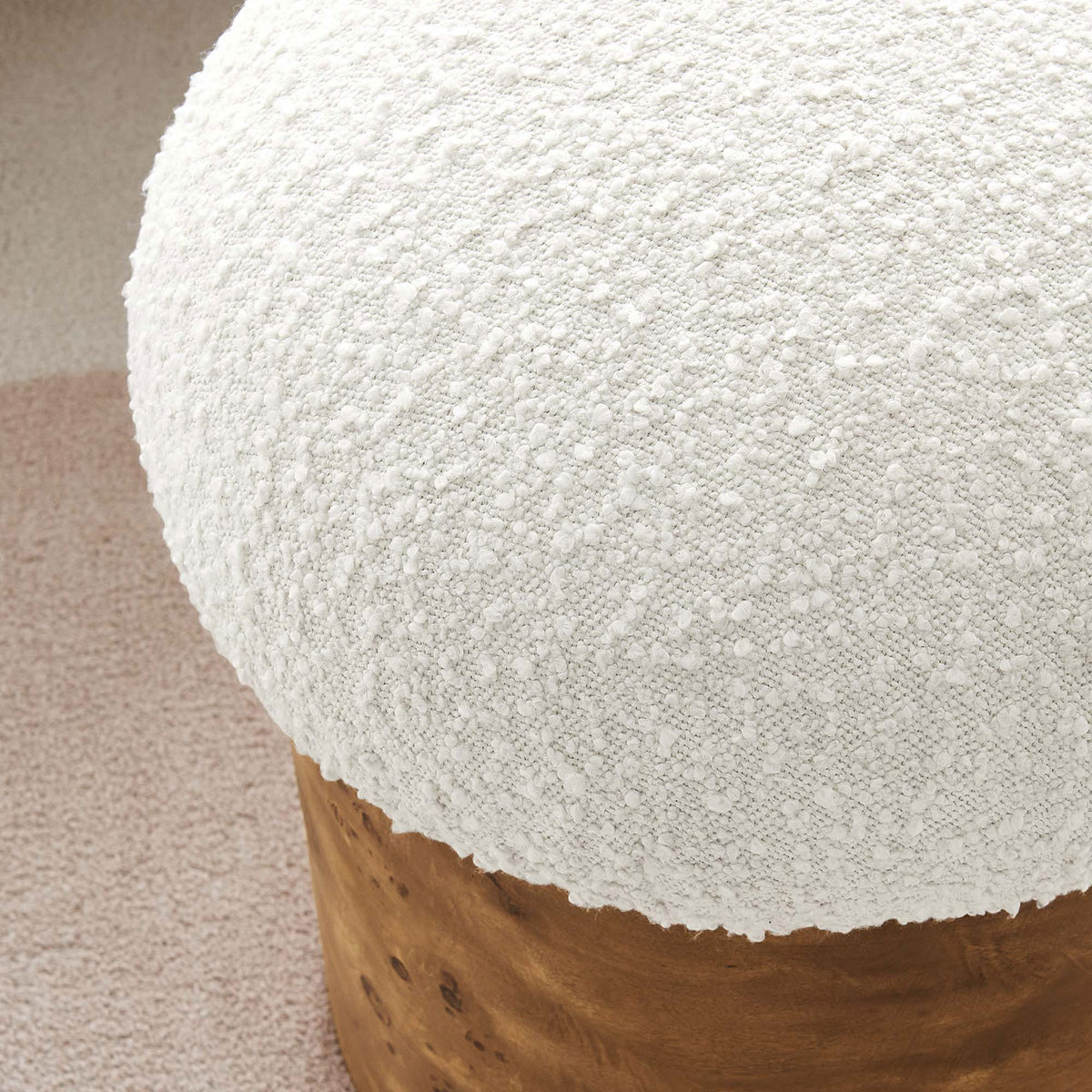 Boucle ottoman in a cozy room, showing plush ivory texture against soft neutral rug || EEI-6850-IVO-BUR || detail_room