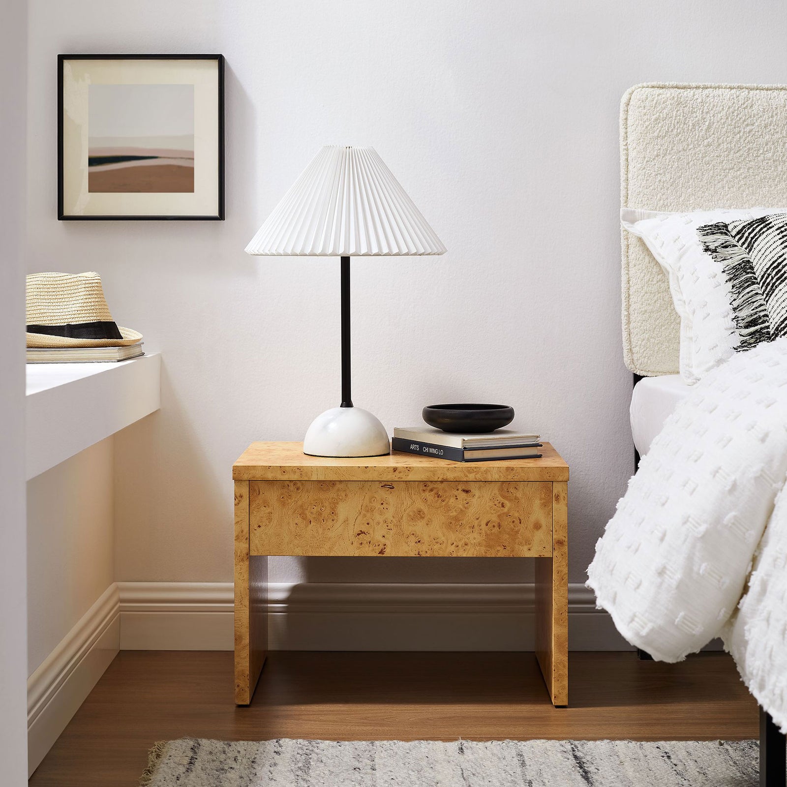 Hudson burl wood nightstand beside the bed showcasing its warm grain and minimalist lines || EEI-6855-BUR || front_angle_room