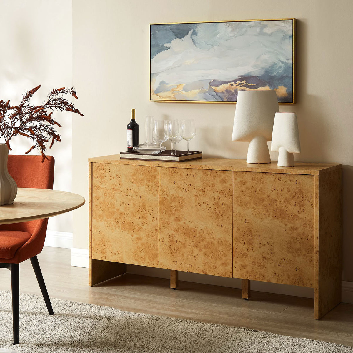 Hudson burl wood sideboard in a modern dining room styled with art, lamps, and wine glasses || EEI-6860-BUR || front_room