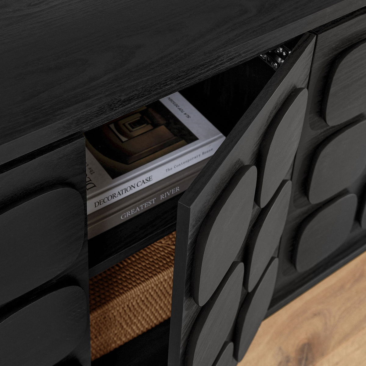 Styled interior of the Toscana sideboard showing hidden storage with books and a woven basket inside || EEI-6862-BLK || storage_open_room
