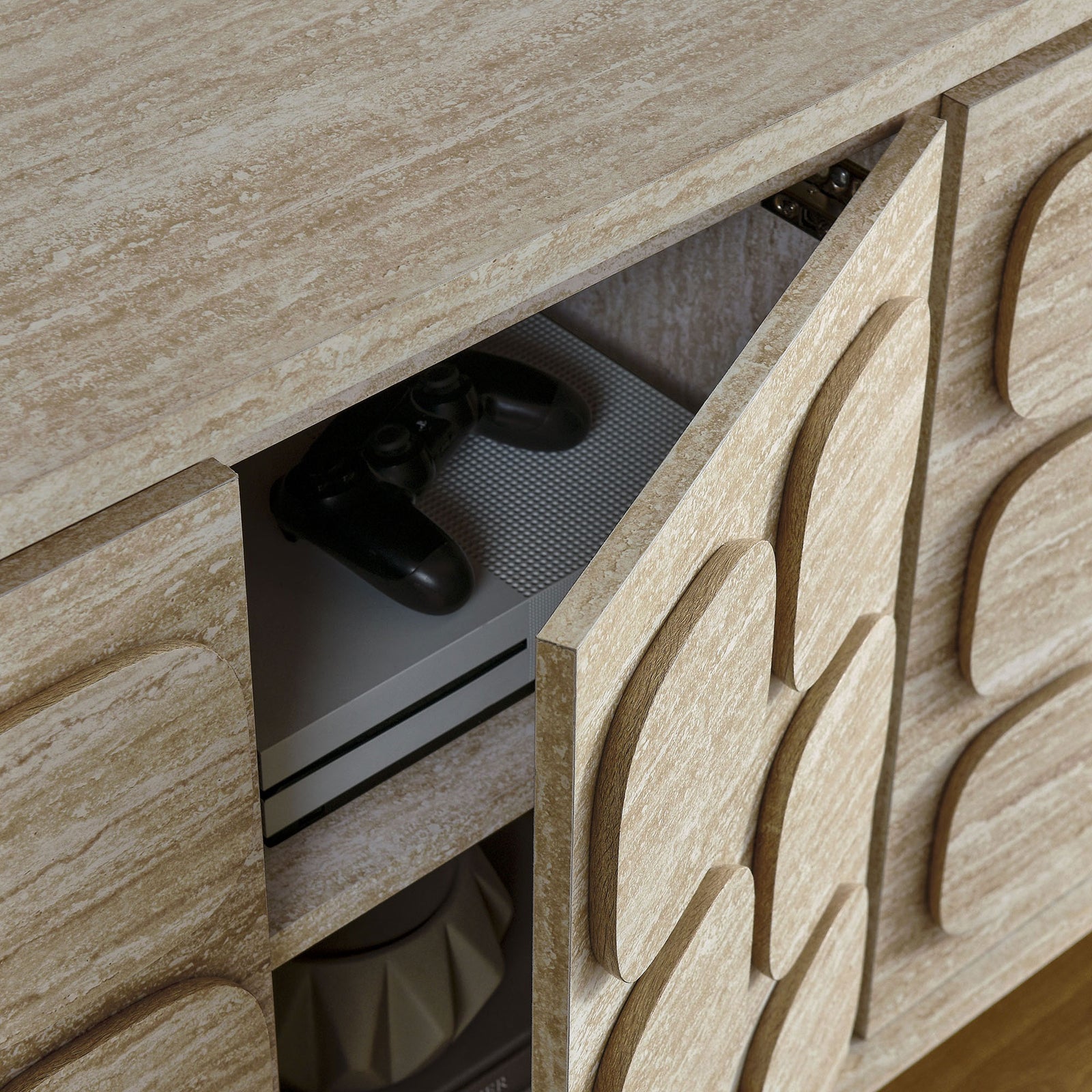 Open cabinet door revealing media consoles and accessories neatly stored inside the sideboard || EEI-6862-TRA || storage_open_room