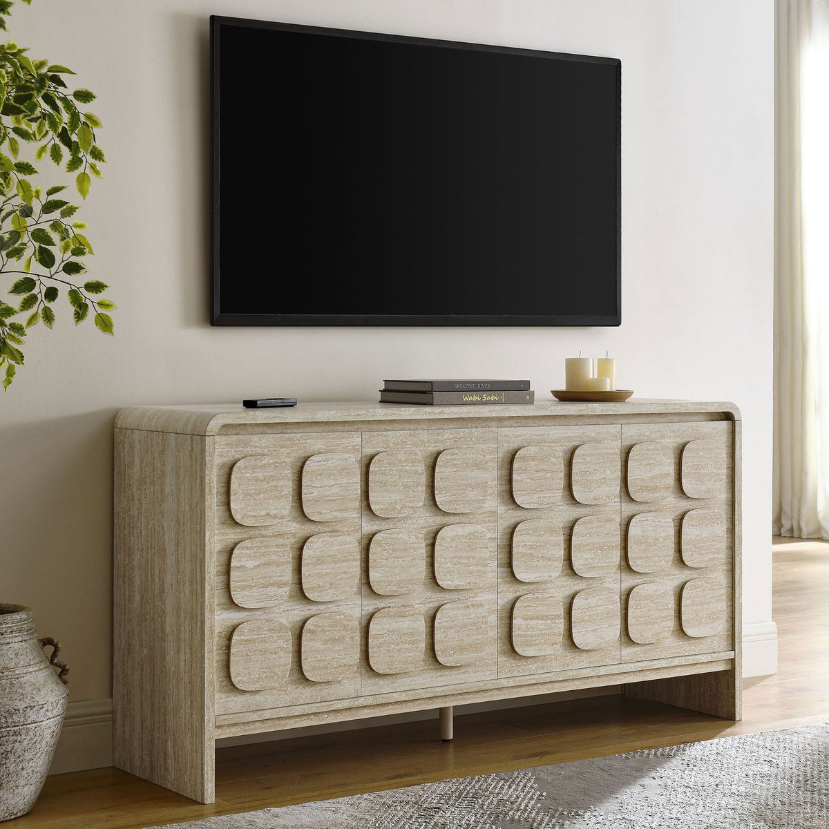 Toscana sideboard styled in a bright living room beneath a wall mounted TV and decor accents || EEI-6862-TRA || front_angle_room