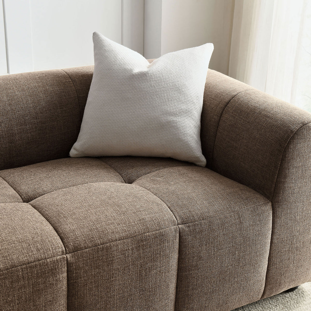 Mocha sofa corner styled with a soft white accent pillow in a bright, airy living room || EEI-6866-MOC || detail_room
