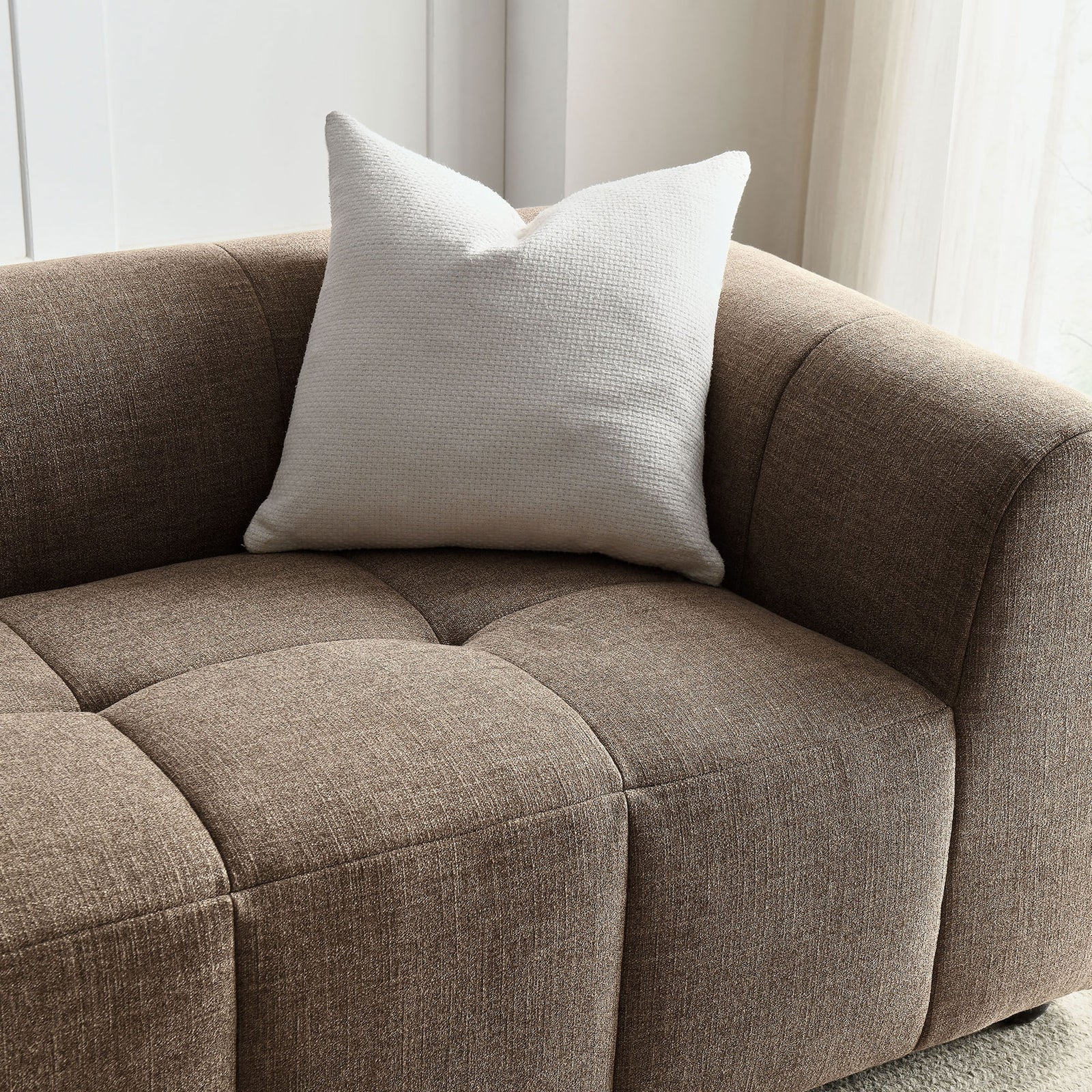 Mocha sofa corner styled with a soft white accent pillow in a bright, airy living room || EEI-6866-MOC || detail_room
