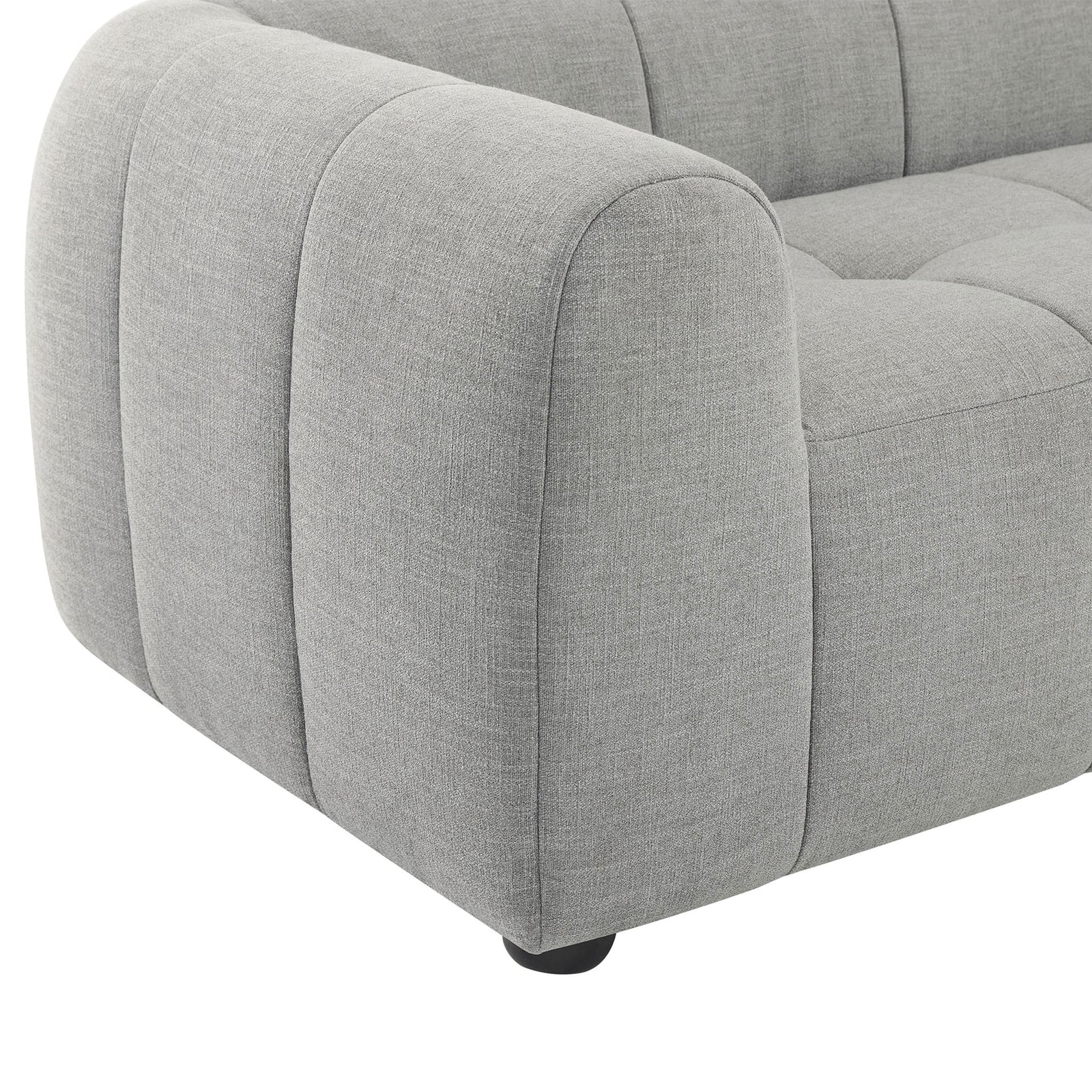 Plush grid-tufted seat and thick armrest in soft pewter fabric anchored by a rounded wood bun foot || EEI-6866-PEW || detail_studio