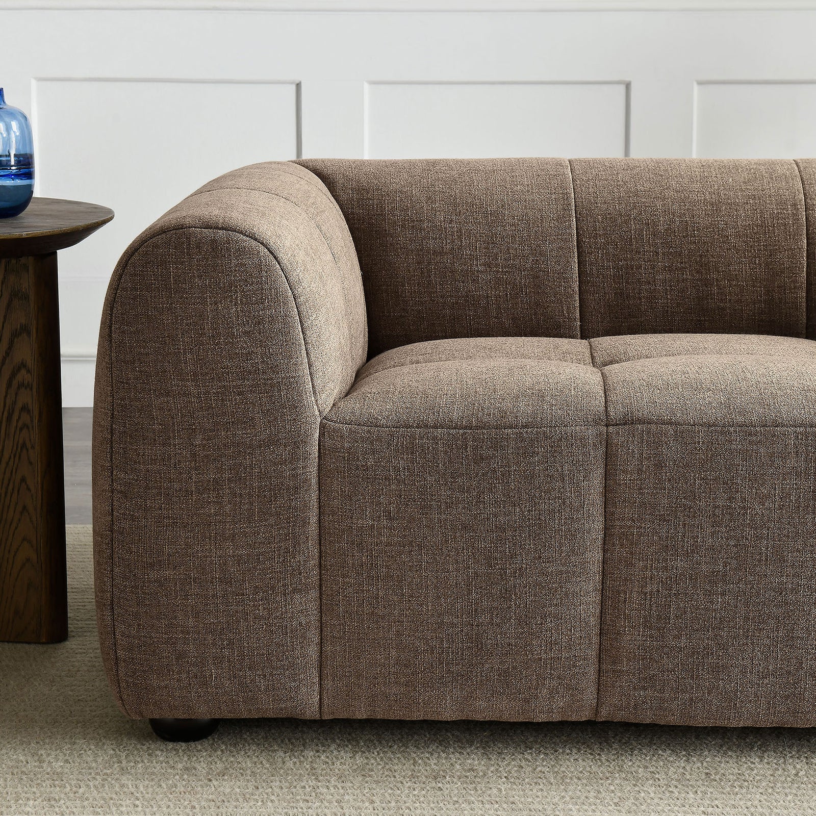 Mocha loveseat arm styled with soft upholstery and subtle grid tufting in a cozy living room setting || EEI-6867-MOC || detail_room