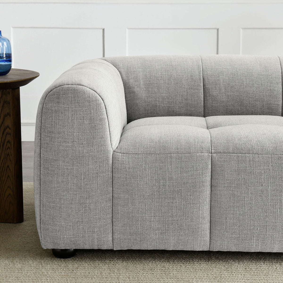 Cozy pewter loveseat arm and seat showing soft textured fabric and inviting deep cushioning beside a wood side table || EEI-6867-PEW || detail_room