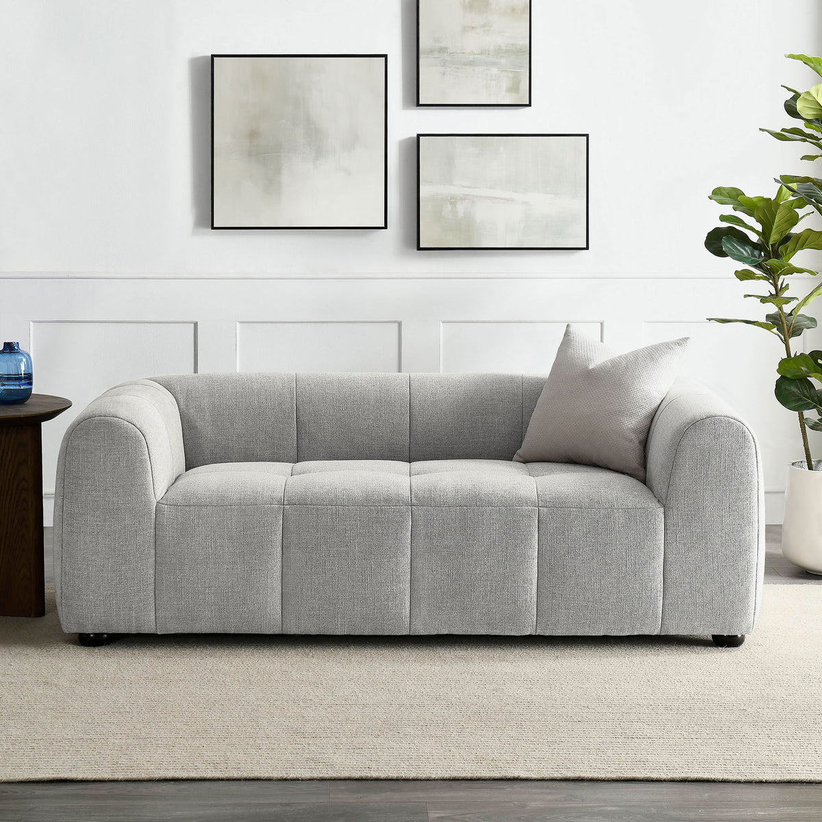 Pewter gray loveseat styled in a bright living room, pairing plush tufted seating with clean modern lines || EEI-6867-PEW || front_room