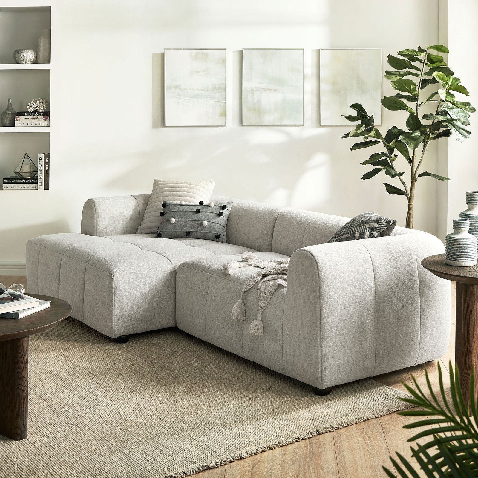 Left-facing linen modular sofa with chaise styled in a bright living room with pillows and throw || EEI-6868-LIN || front_angle_room