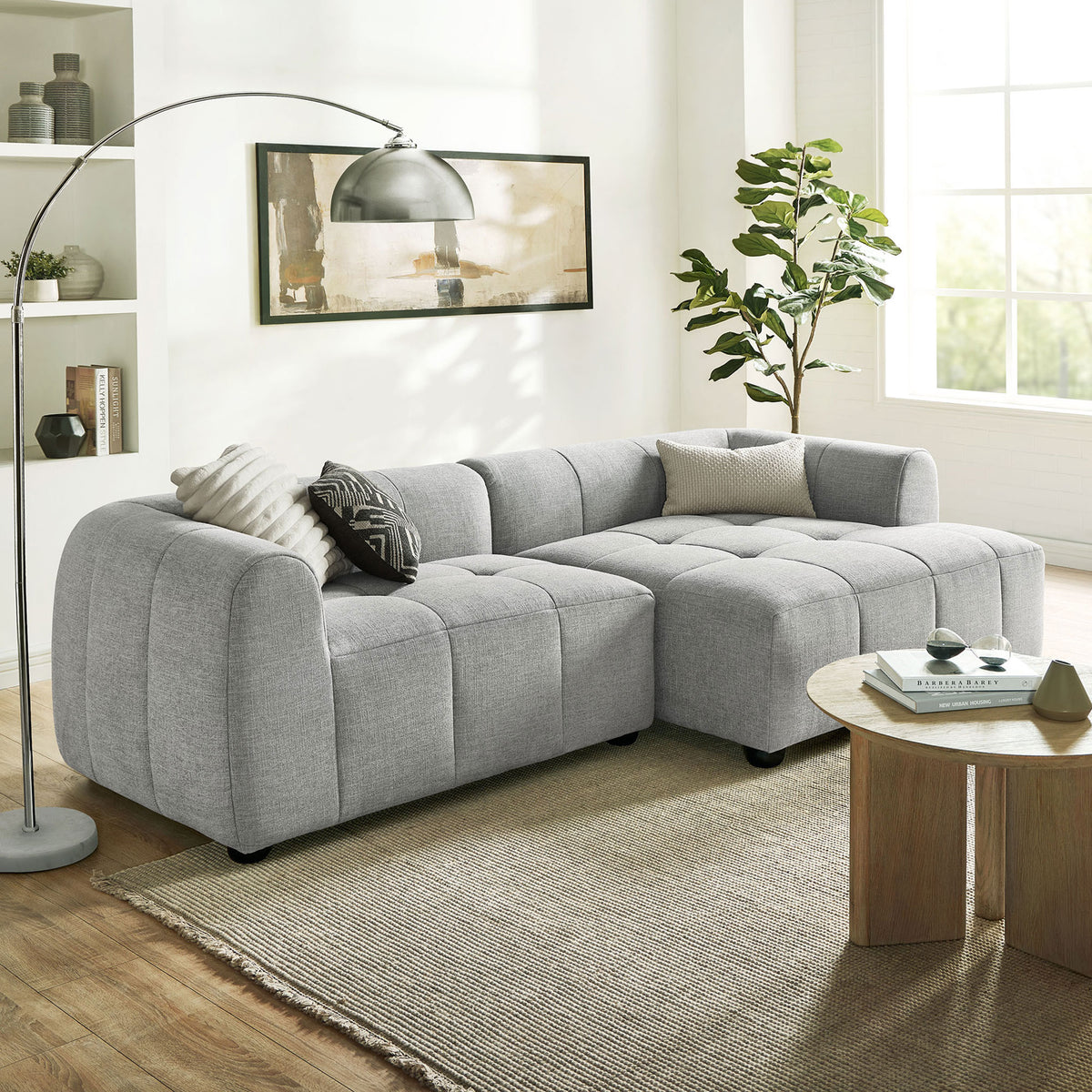 Liana right-facing sectional arranged in a modern living room with floor lamp, rug, and coffee table. || EEI-6869-PEW || front_angle_room