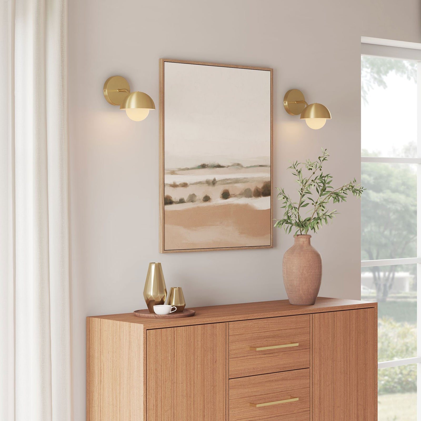Pair of brass globe sconces frame the artwork and wash the console area in soft golden light || EEI-6871-BRA || front_angle_on_room