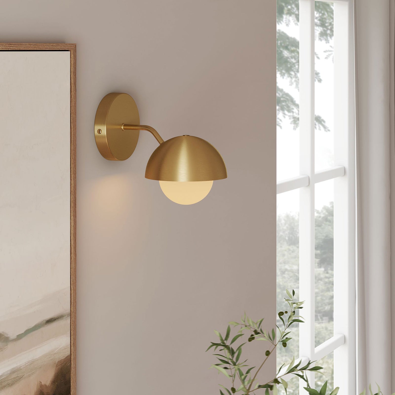 Single brass globe wall sconce glows by the window, lending a serene, upscale feel to the room || EEI-6871-BRA || front_angle_on_room