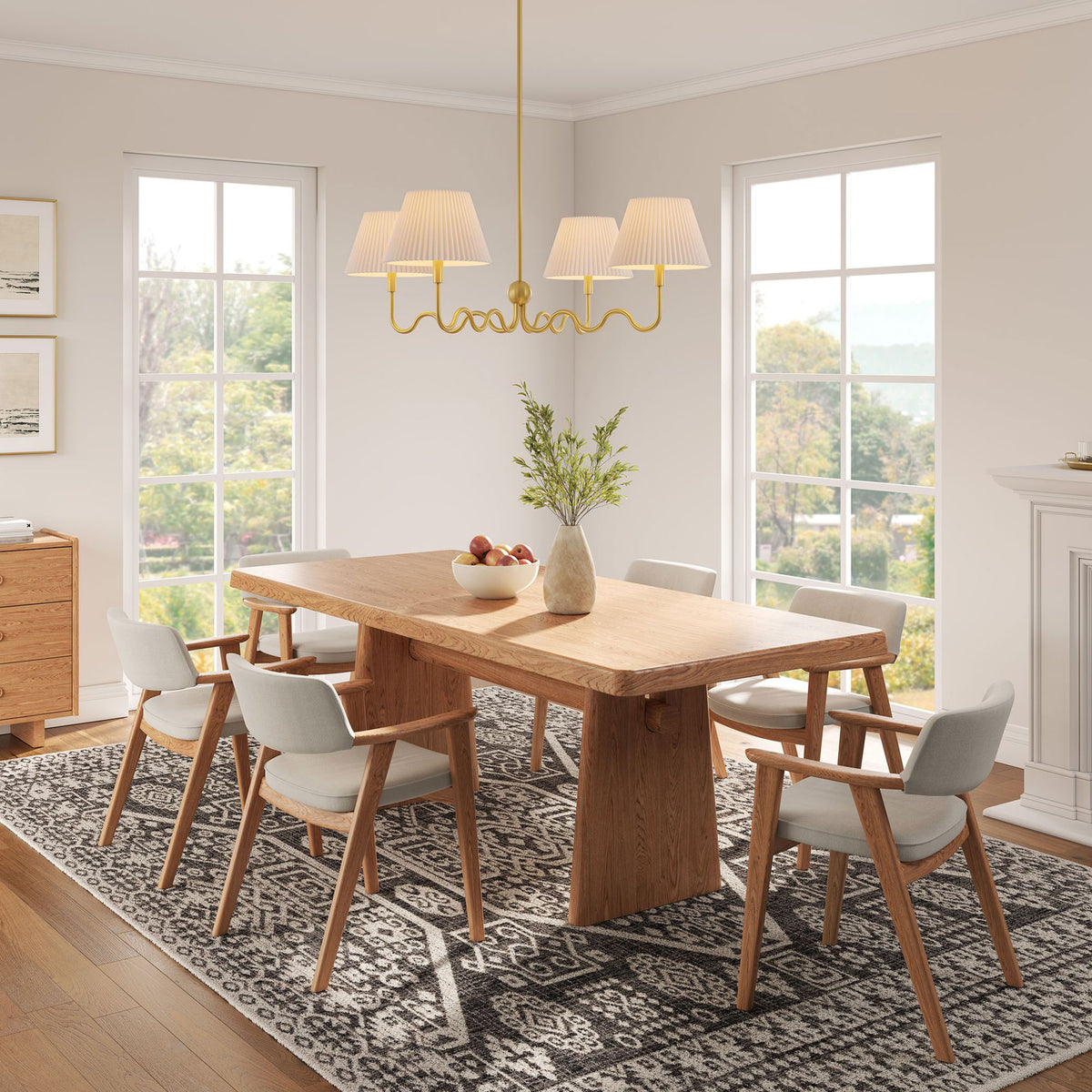 Modern brass chandelier with wavy arms and white pleated shades elevates a cozy dining space || EEI-6875-BRA || front_angle_on_room