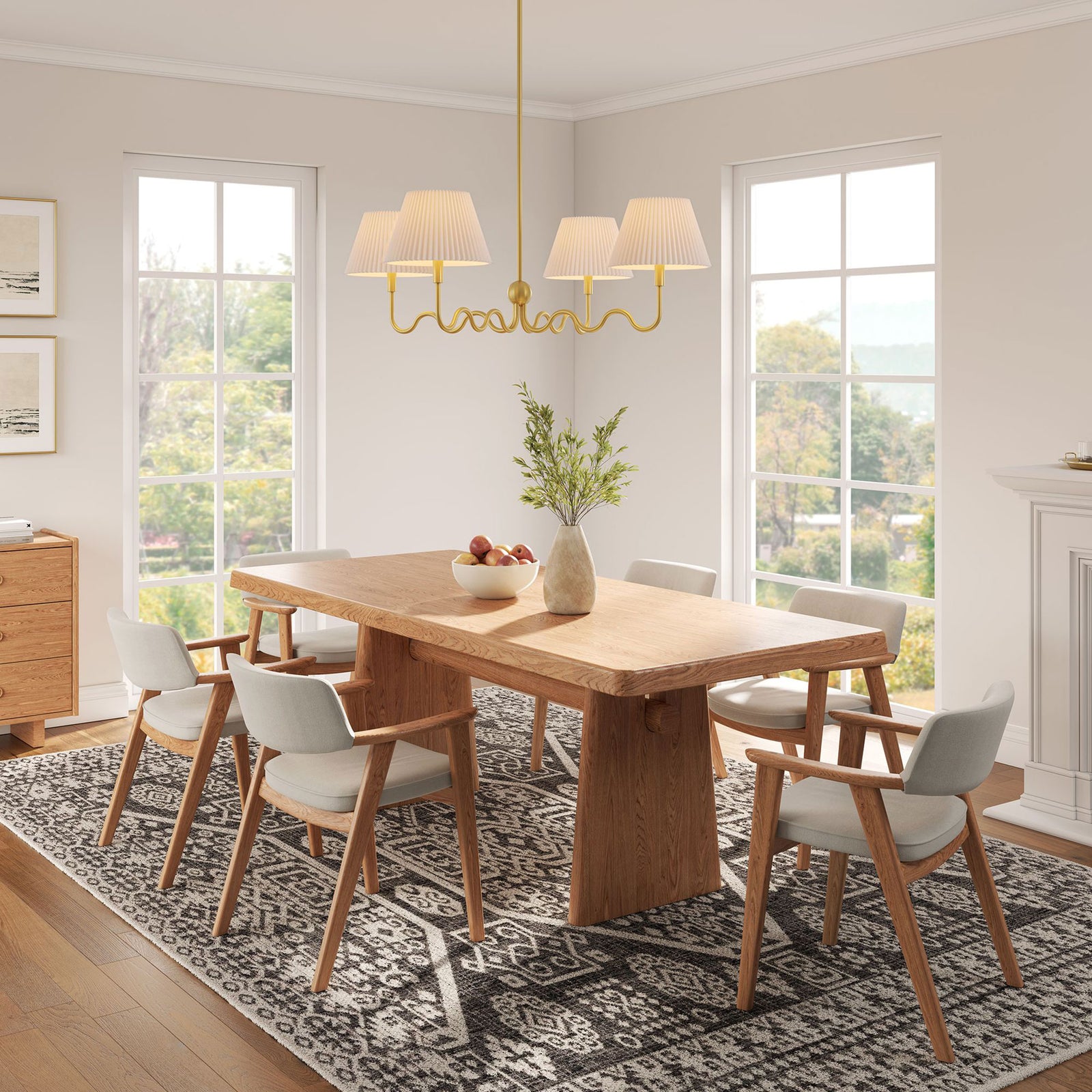 Modern brass chandelier with wavy arms and white pleated shades elevates a cozy dining space || EEI-6875-BRA || front_angle_on_room
