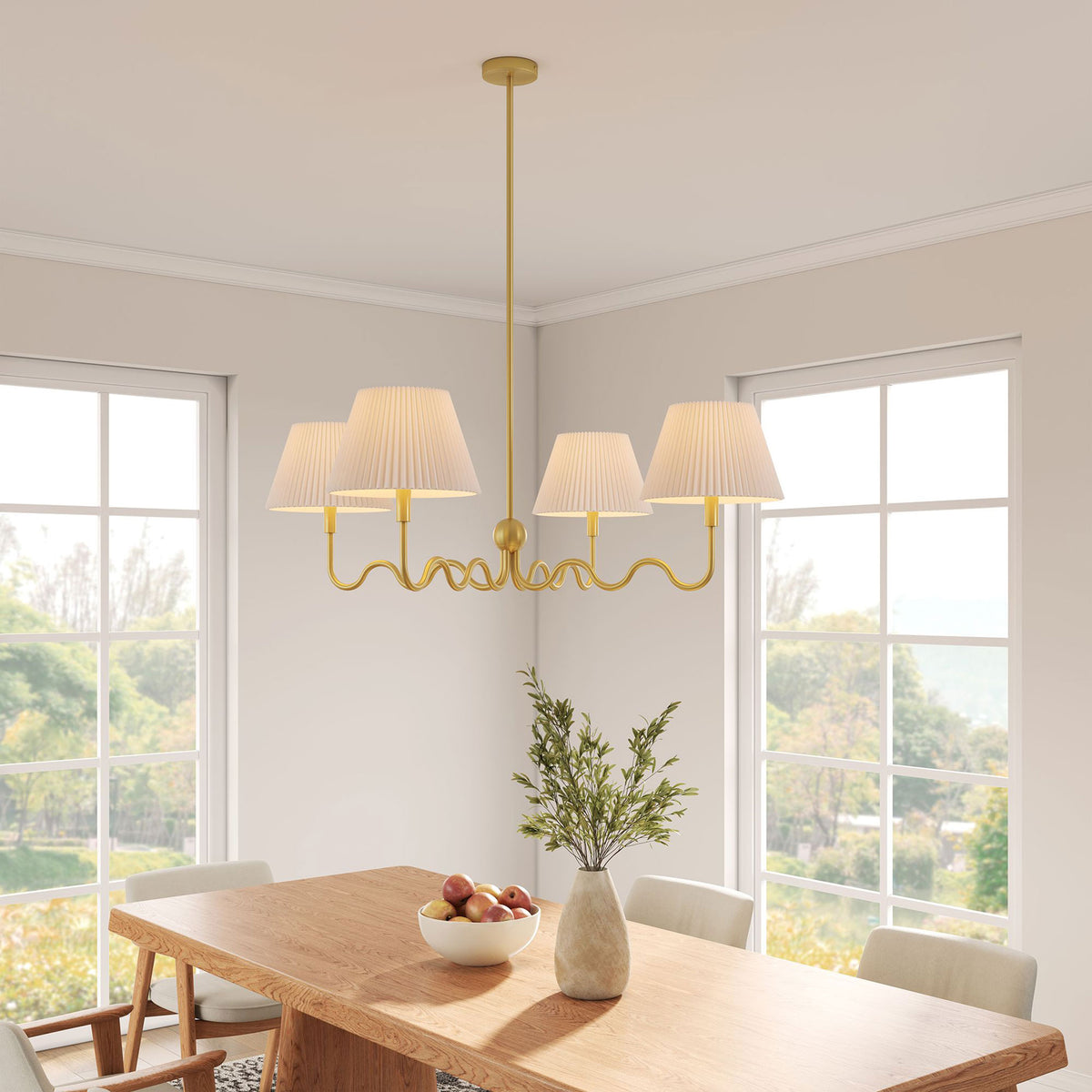 Brass squiggle chandelier casts a warm glow over the table with four pleated shades || EEI-6875-BRA || front_angle_on_room