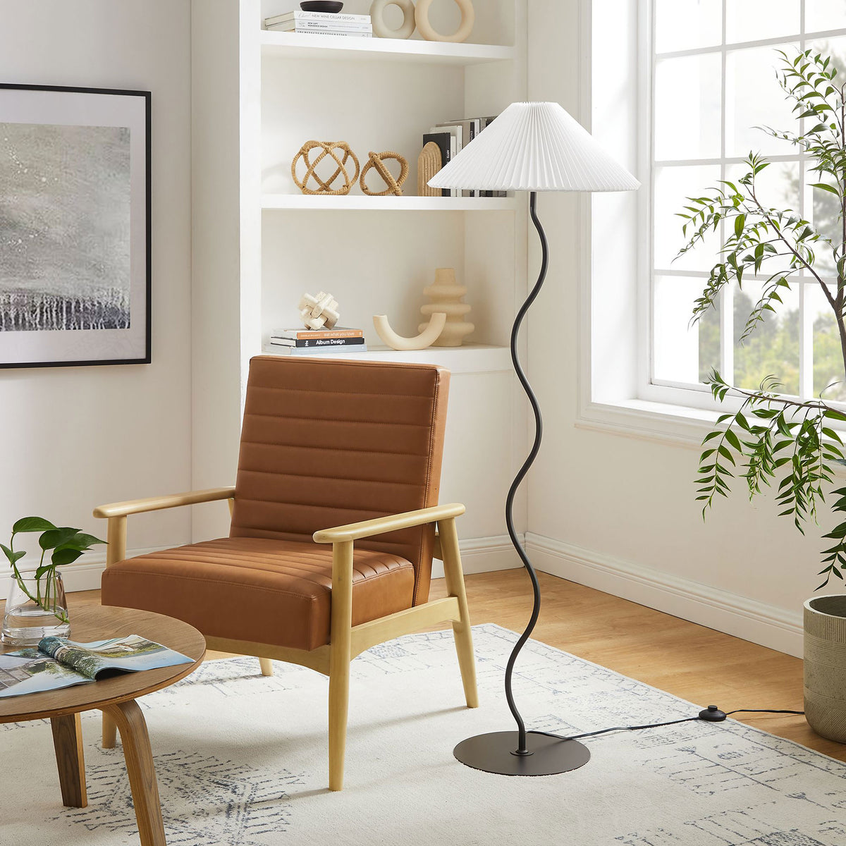 Black squiggle floor lamp styled beside a modern armchair, adding sculptural presence to a bright living room. || EEI-6877-BLK || front_room