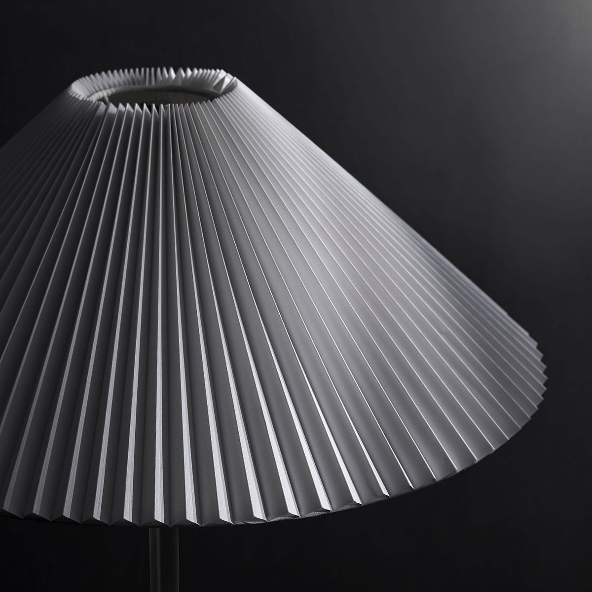 Illusion floor lamp shade with bold pleated texture standing out against a dark modern backdrop || EEI-6879-BLK || shade_studio