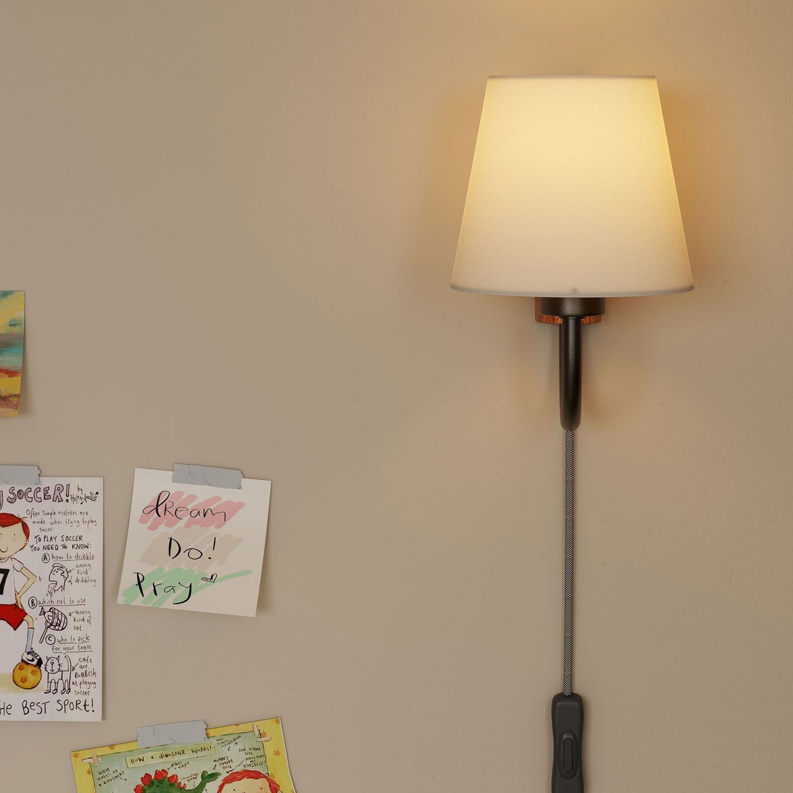 Glowing U arm wall sconce brings warm task lighting to a creative wall of notes and drawings || EEI-6880-WAL-BLK || front_on_room