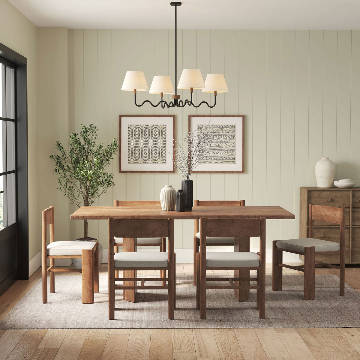 Modern four light pendant adds inviting charm above a dining table with its sculptural curves || EEI-6883-WAL-BLK || front_on_room