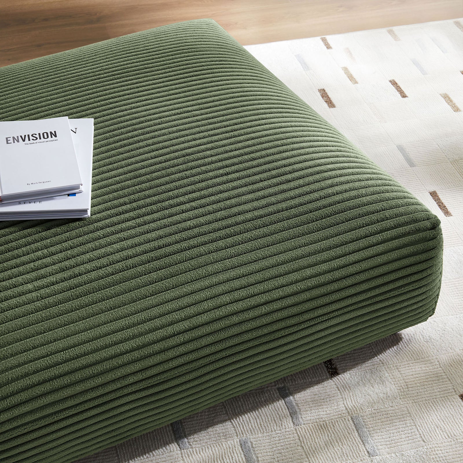 Ottoman surface styled on a modern rug with books to show its use as a casual coffee table. || EEI-6888-FRN || detail_room