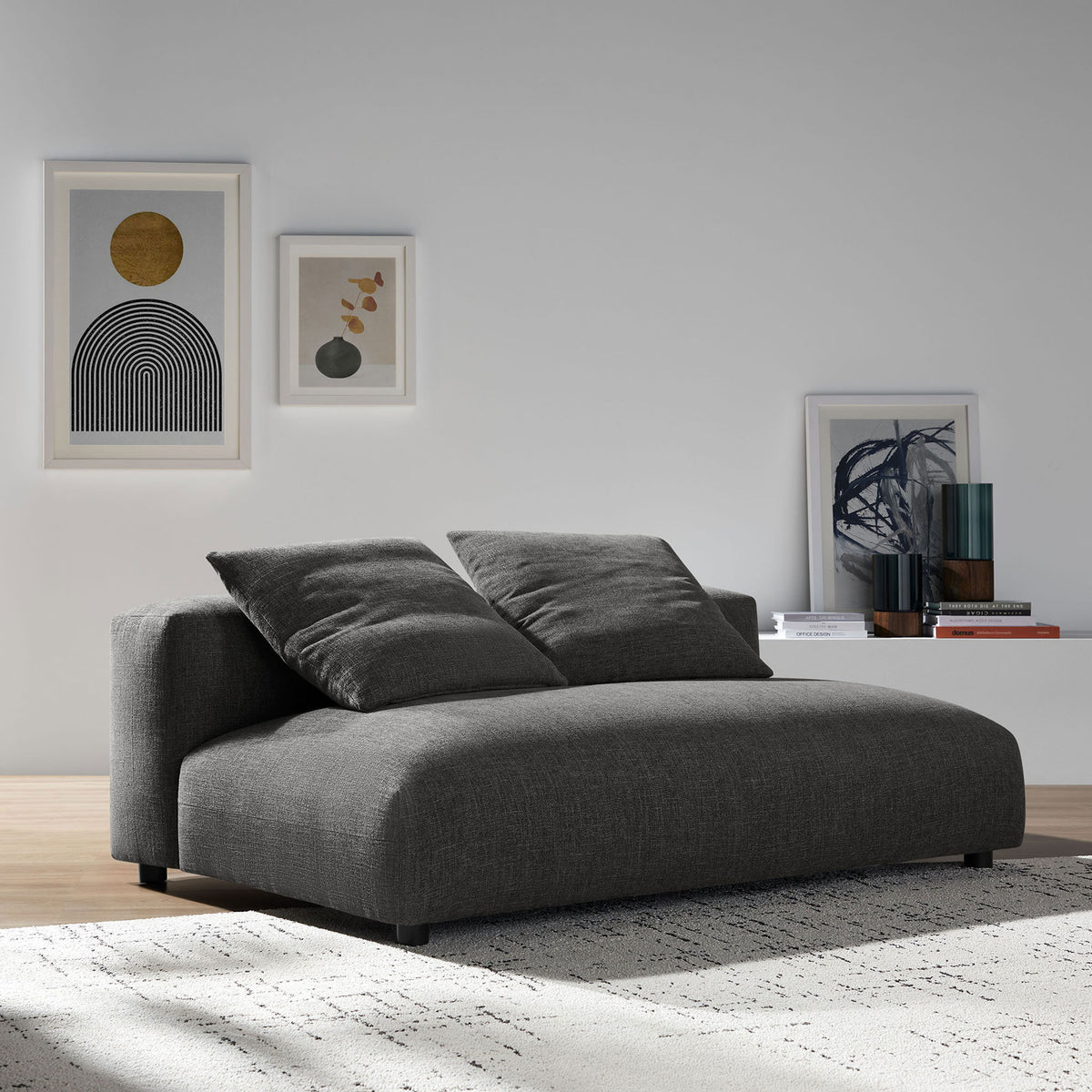 Charcoal armless loveseat in a contemporary living room, creating a cozy lounge centerpiece. || EEI-6891-CHA || front_angle_room