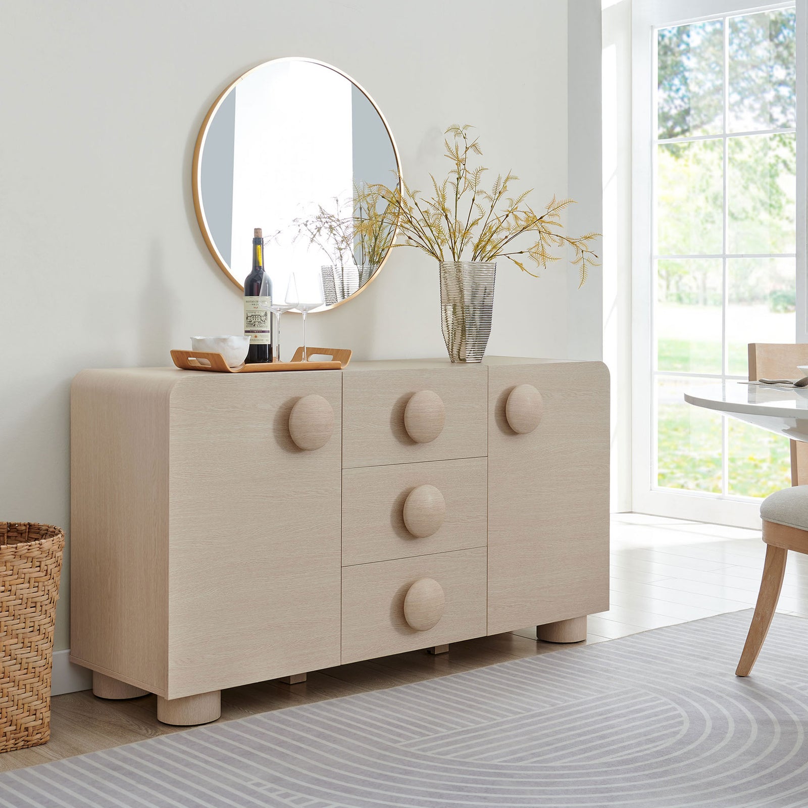 Sonnet ash sideboard styled with decor and trays, bringing soft curves and warmth to an airy dining space. || EEI-6892-ASH || front_angle_room