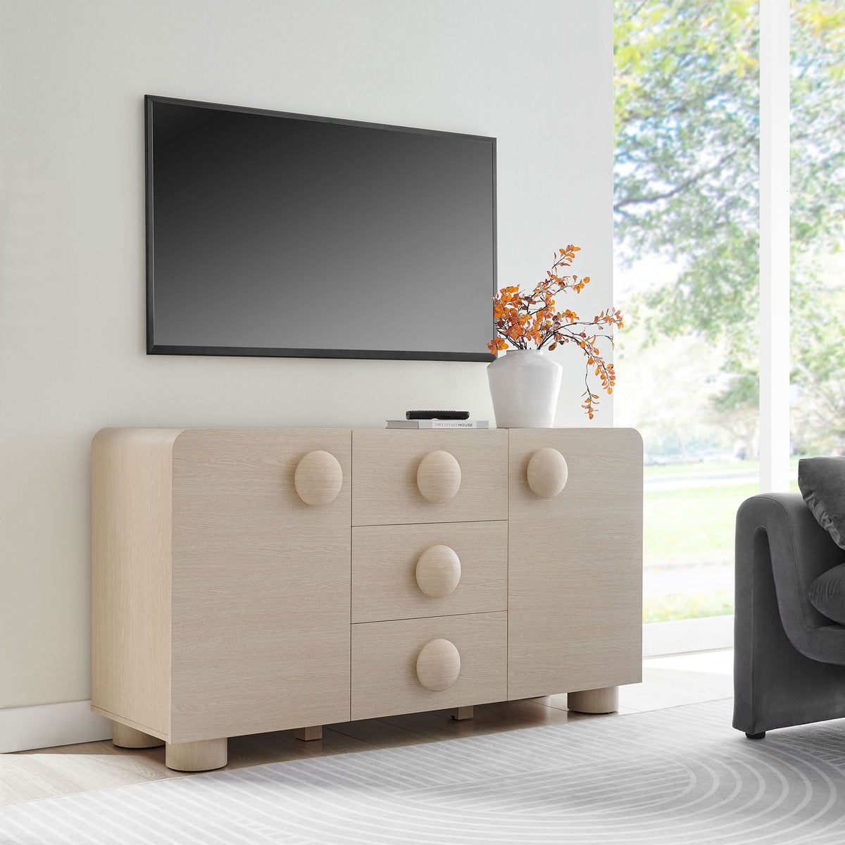 Sonnet sideboard used as a streamlined TV console beneath a wall-mounted screen in a modern living room. || EEI-6892-ASH || front_room