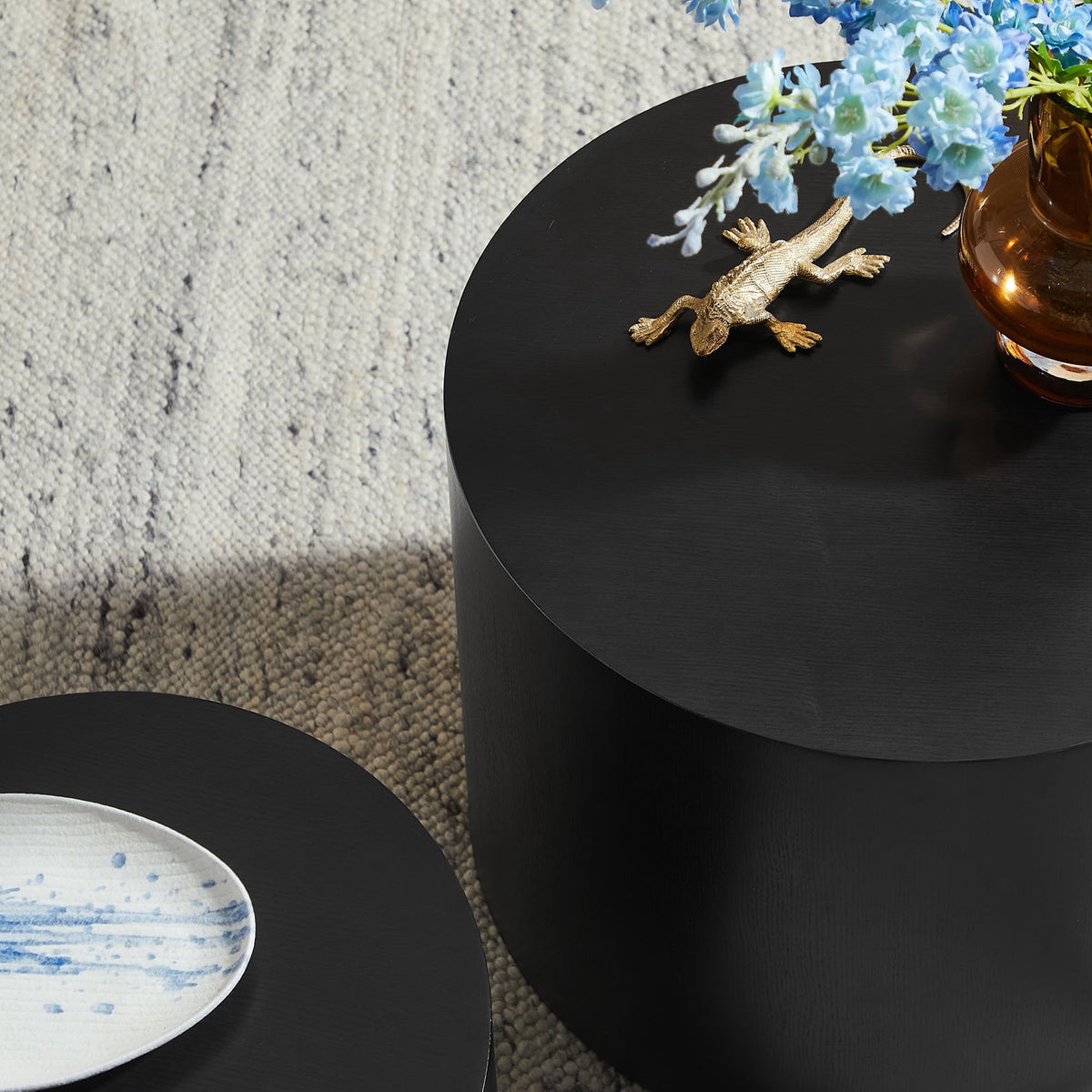 Round black drum tables offer smooth surfaces for decor and everyday use || EEI-6893-BLK || detail_room