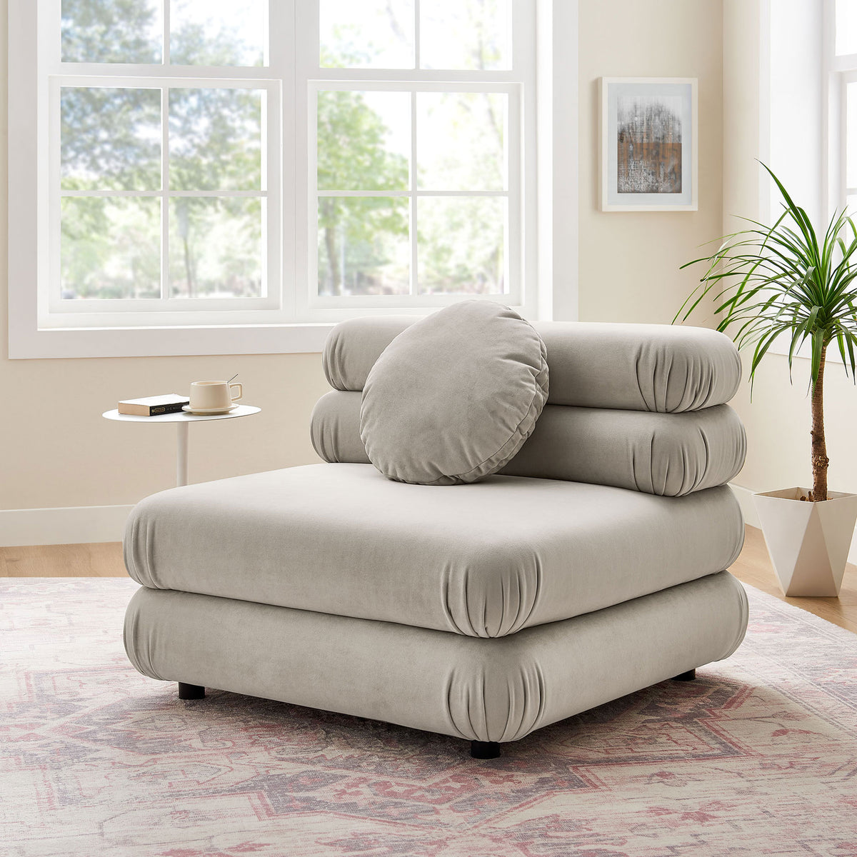 Elevate your lounge with this modular armless chair and round pillow in a serene almond hue || EEI-6896-ALM || front_angle_room