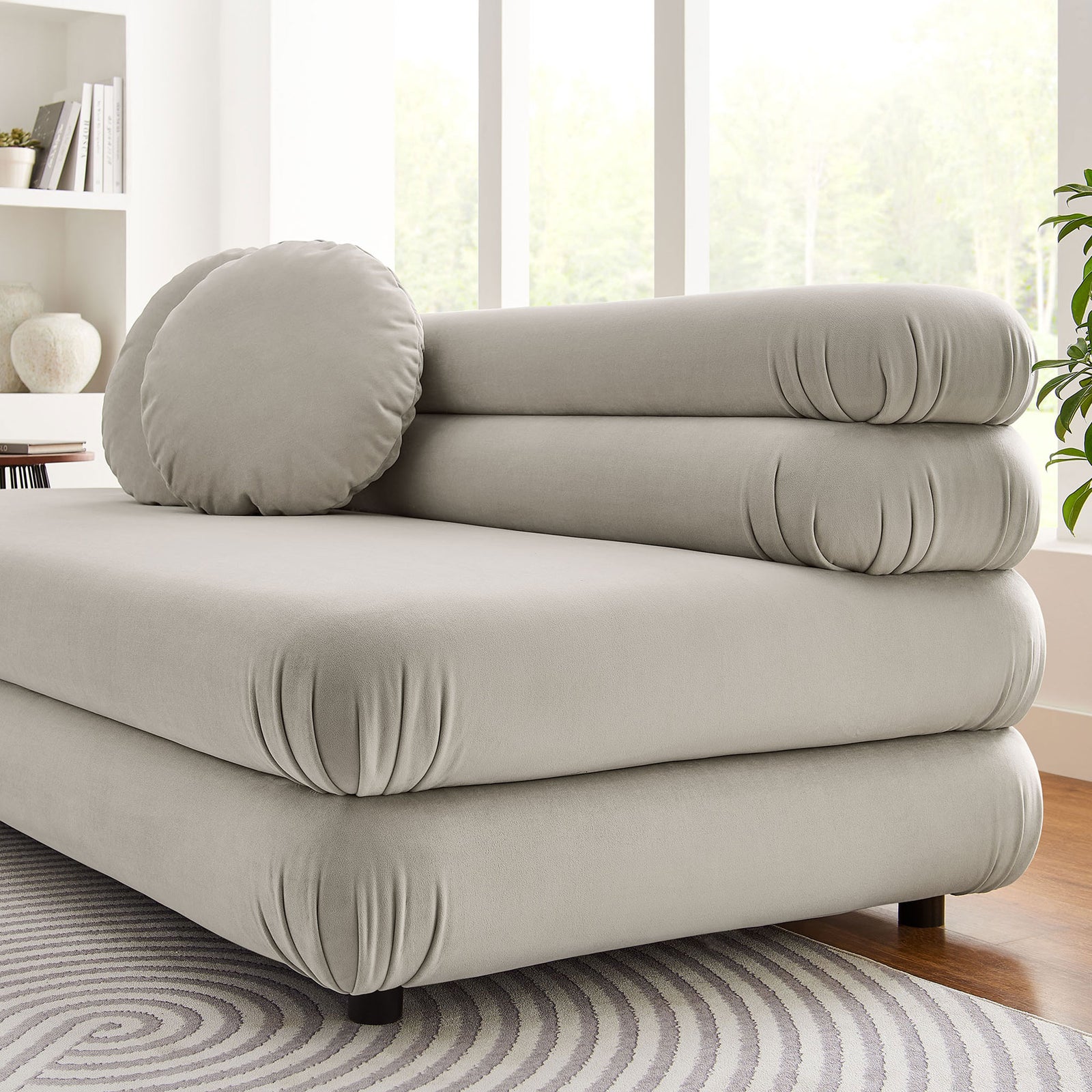 Jubilee almond velvet armless loveseat styled in a bright living room with sculpted cushions and round pillow || EEI-6897-ALM || detail_room