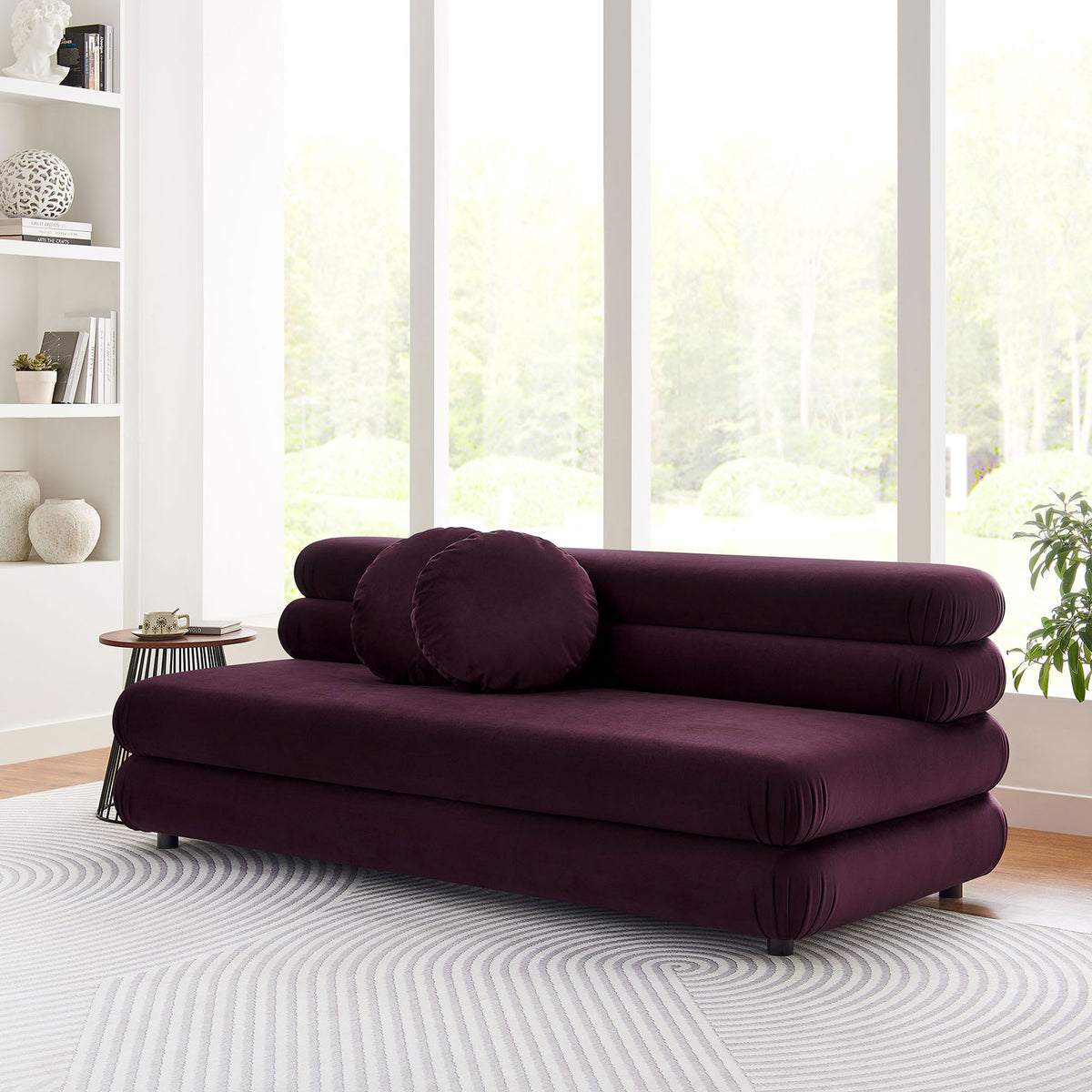 Armless mulberry velvet loveseat beside sleek side table in bright contemporary living space || EEI-6897-MUL || front_angle_room