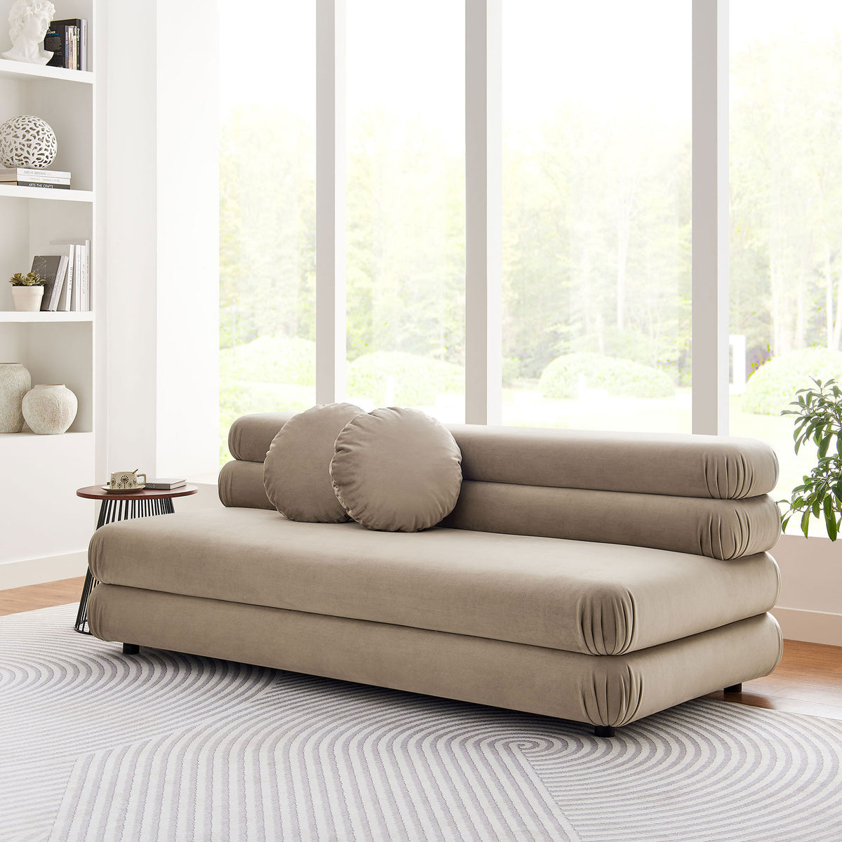 Armless taupe velvet loveseat styled on a patterned rug with modern decor accents || EEI-6897-TAU || front_angle_room