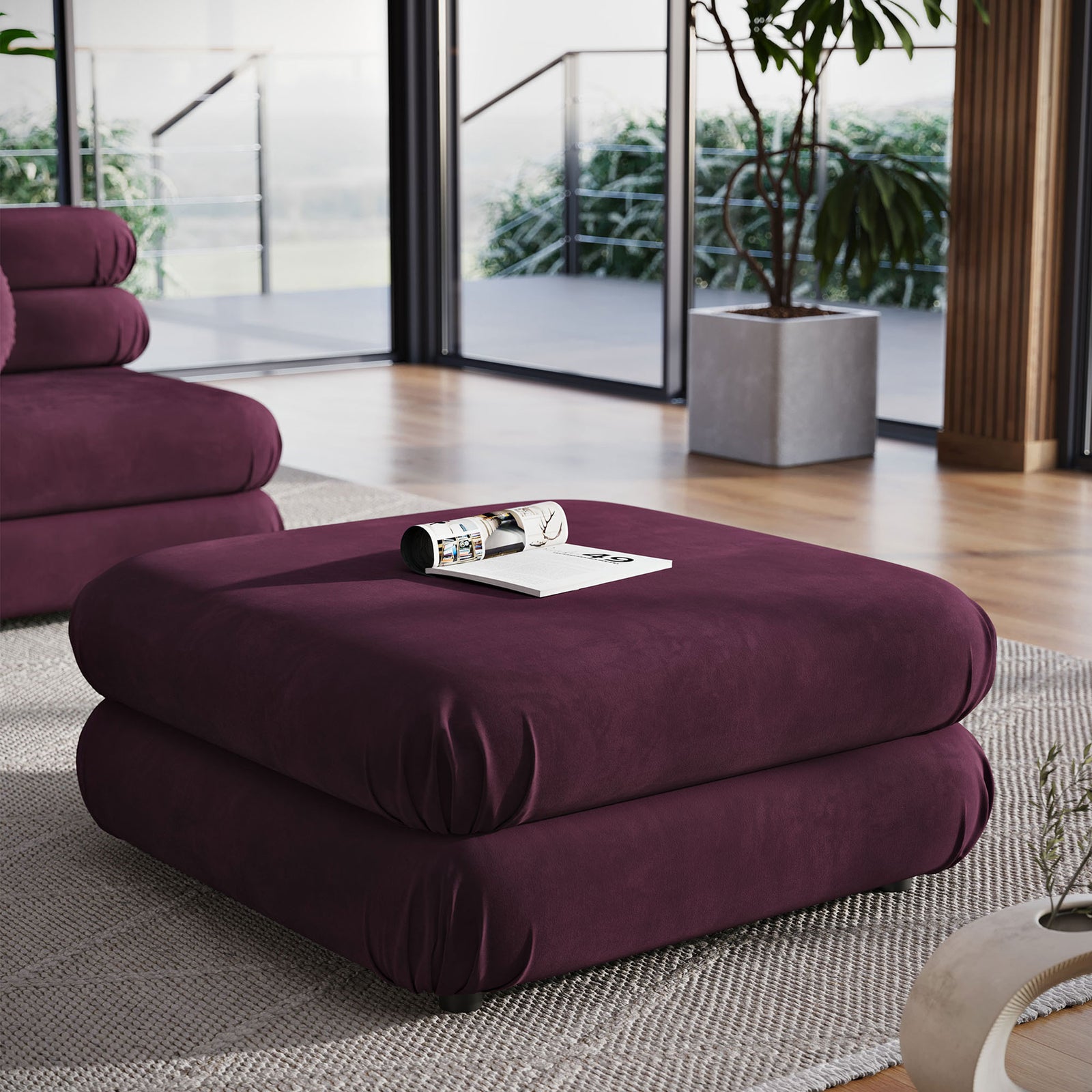 Mulberry velvet ottoman creating a cozy lounge spot in a bright room with floor-to-ceiling windows || EEI-6899-MUL || front_angle_room