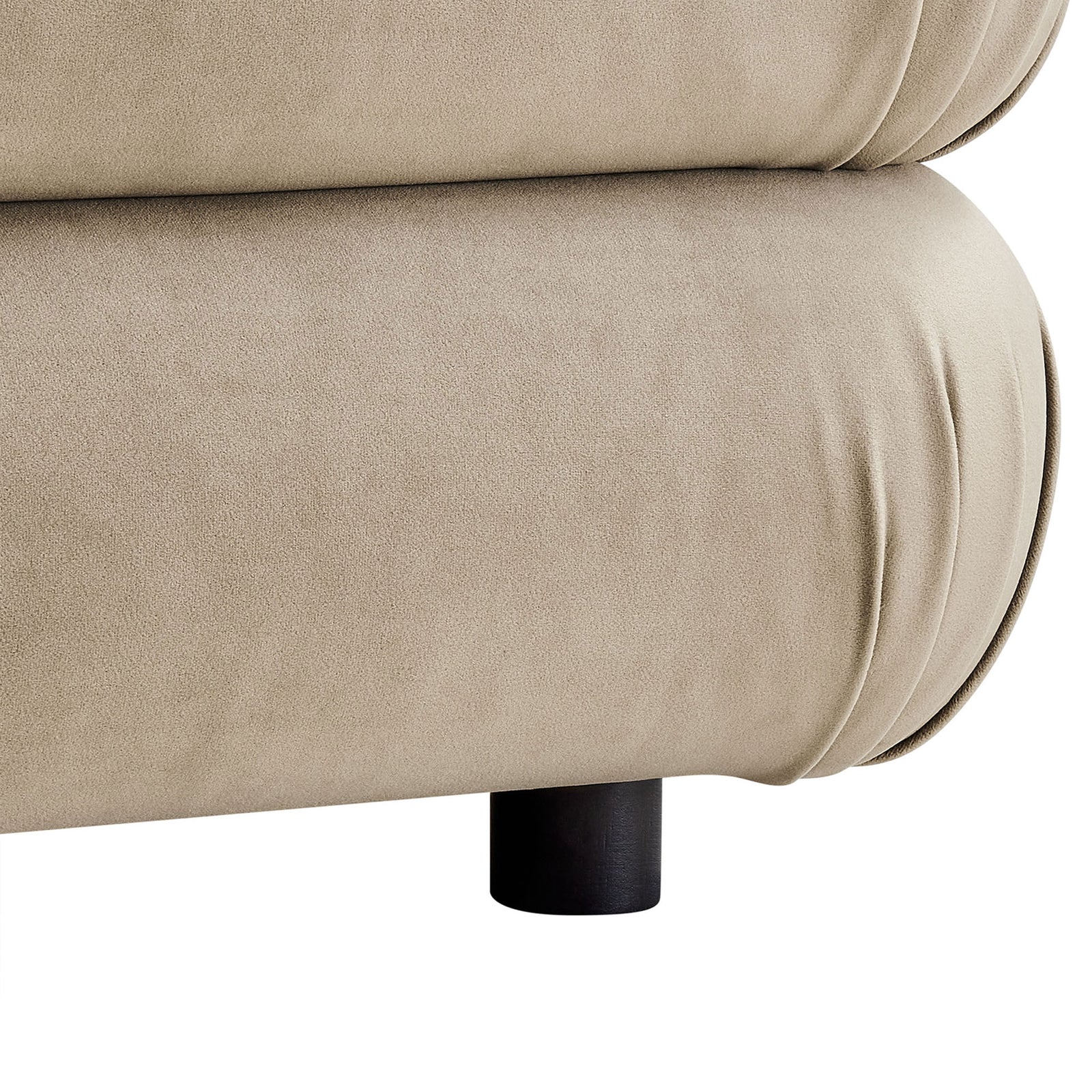 Close view of ottoman base showing soft velvet upholstery, rounded edge seams, and sturdy black feet || EEI-6899-TAU || leg_studio